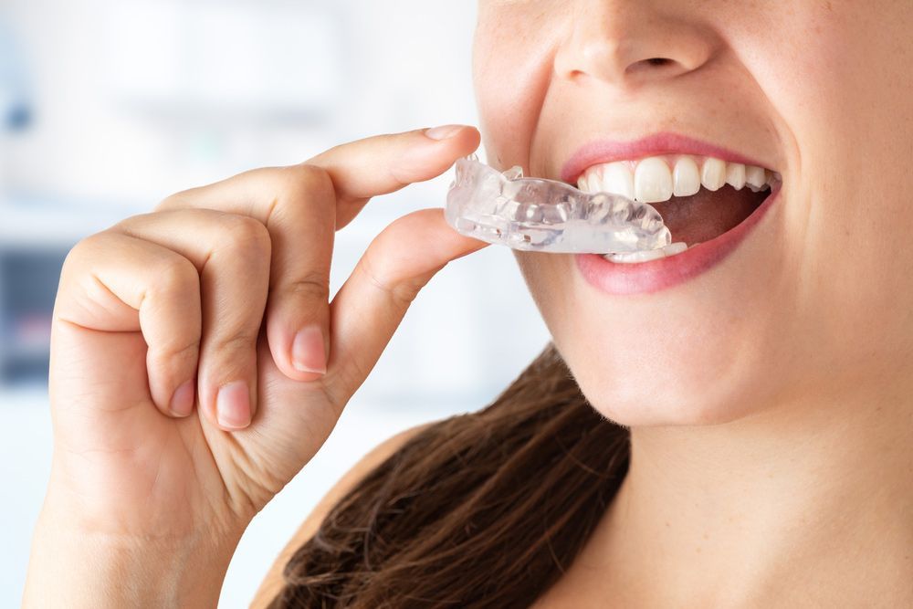 Woman with an Orthodontic silicone trainer — Dental Clinic in Buderim, QLD