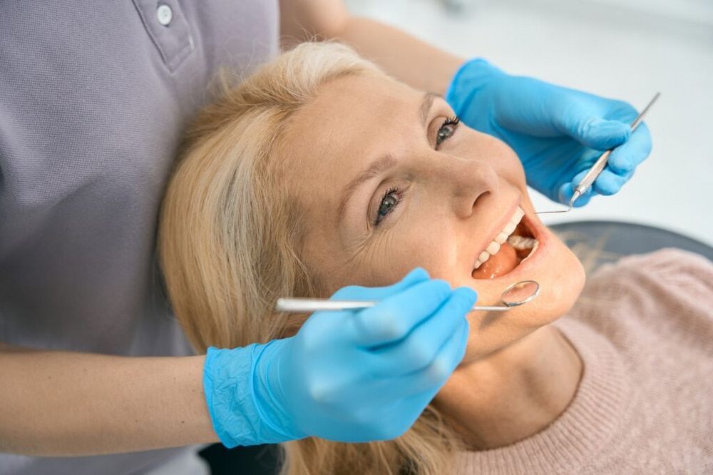 A Woman is Having Her Teeth Examined by a Dentist — Dental Clinic in Buderim, QLD