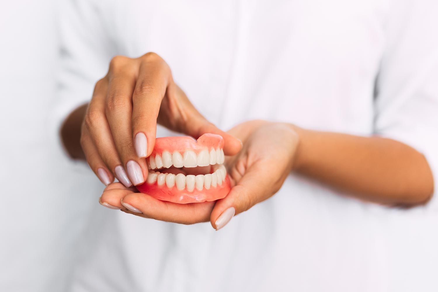 A Dentist Holding Dentures