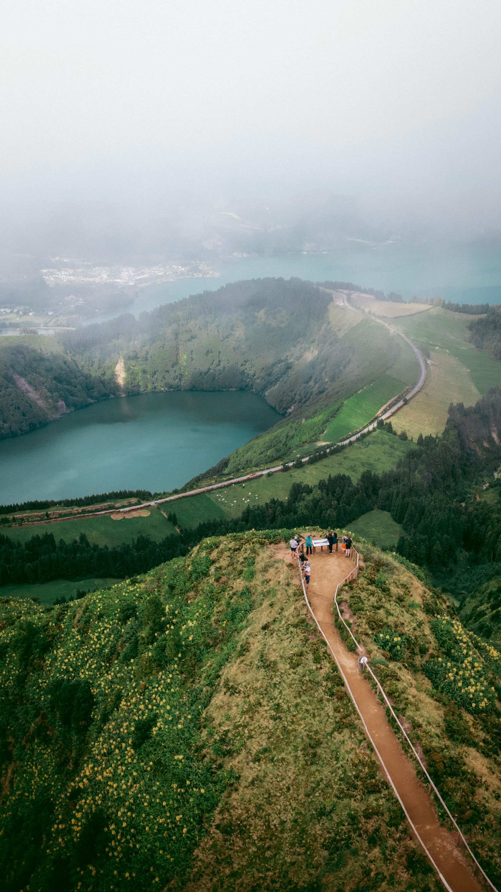 An aerial view of a path leading to a lake on top of a mountain.