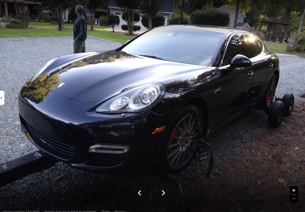 Fuel nozzle pouring dark liquid into a metal container.