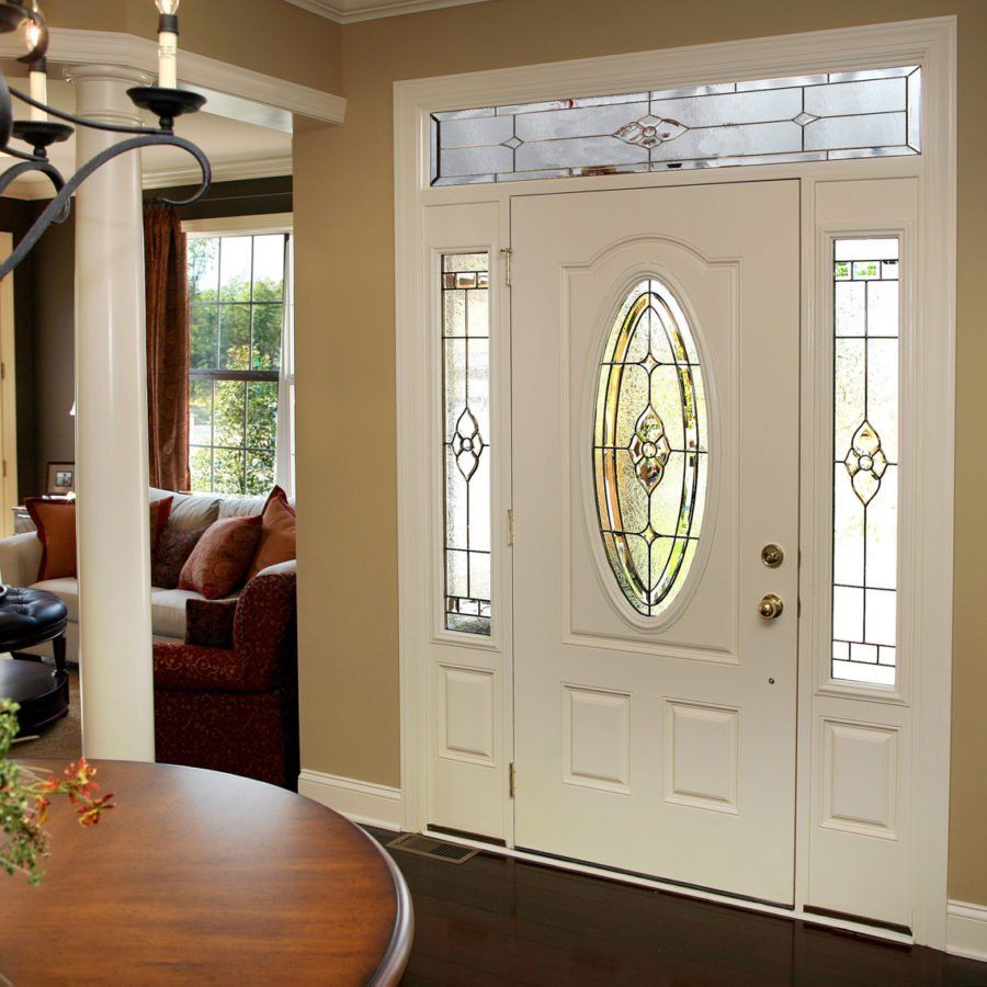 A white door with a stained glass window in a living room