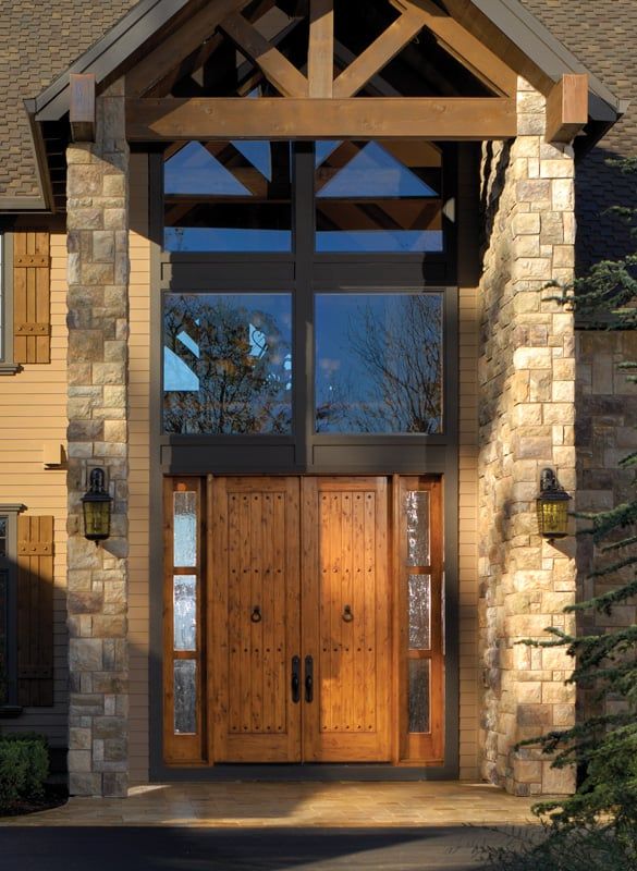 A house with a wooden door and a stone wall