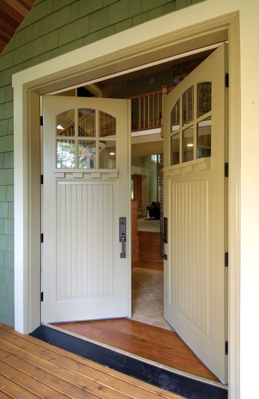 A white door is open to a room with a wooden floor