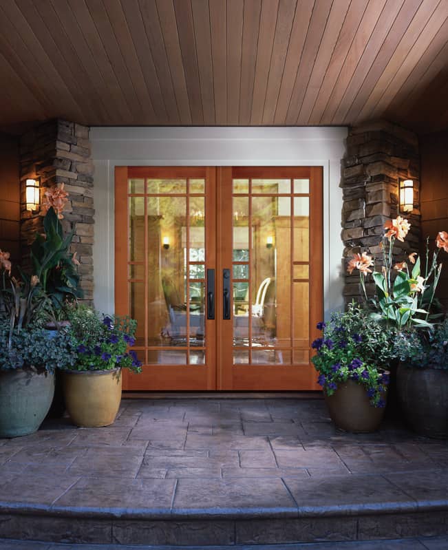 The front door of a house with potted plants in front of it