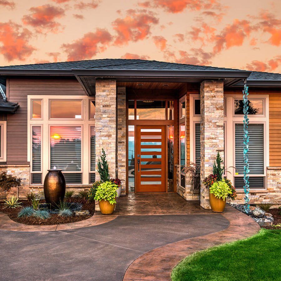 The front of a house with a sunset in the background
