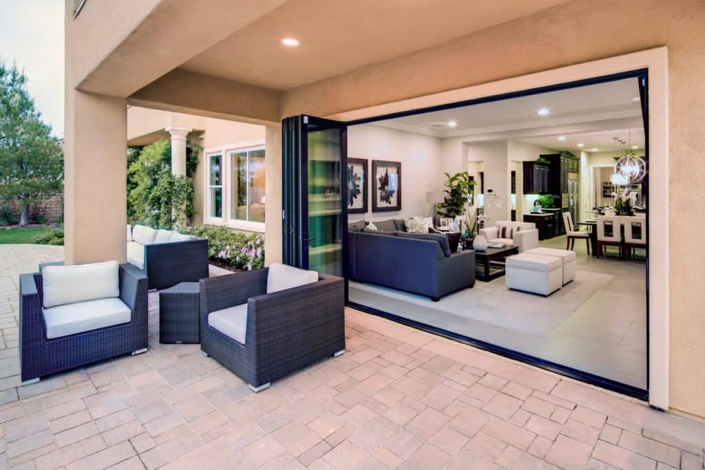 A living room with a lot of furniture and a large sliding glass door