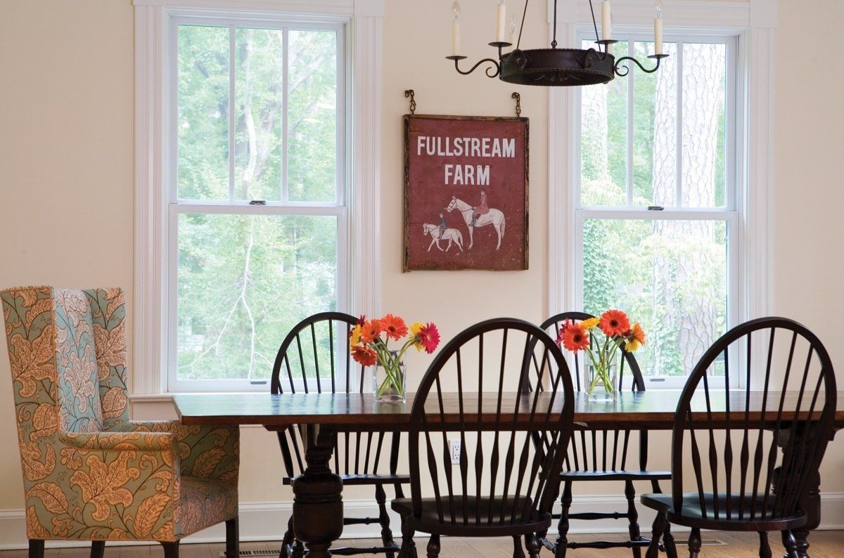 A dining room with a table and chairs and a sign that says fullstream farm