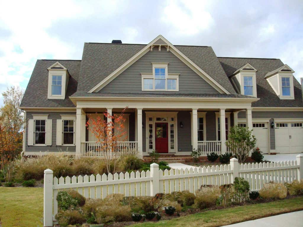 A large house with a white picket fence around it