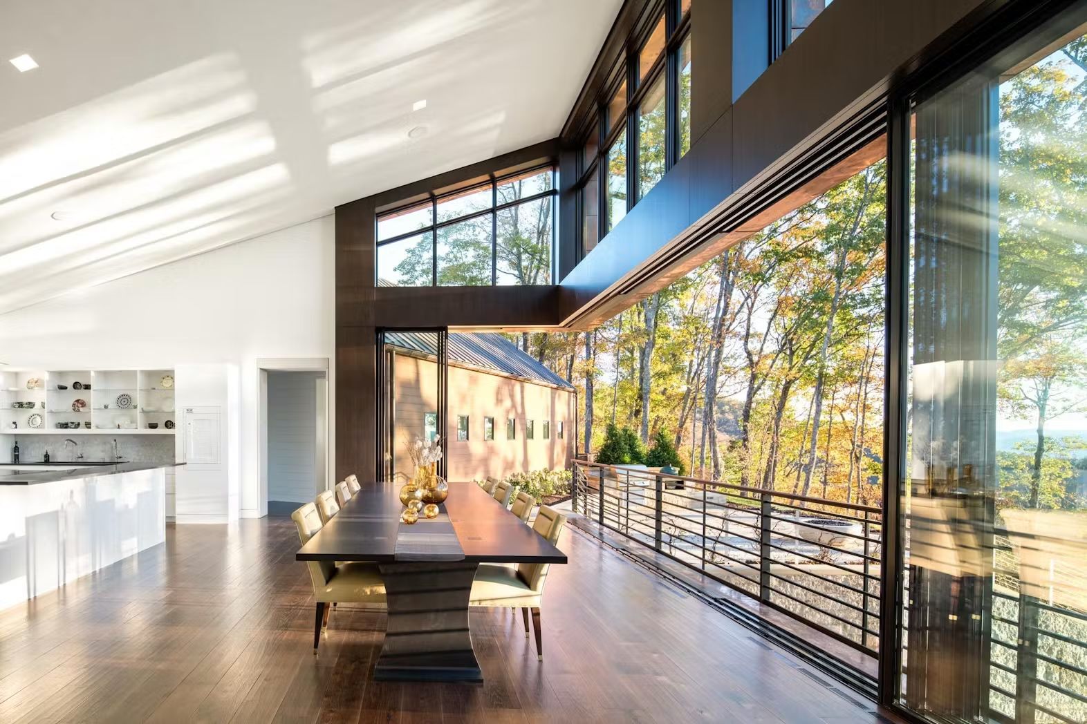 A large dining room with a table and chairs and a lot of windows.