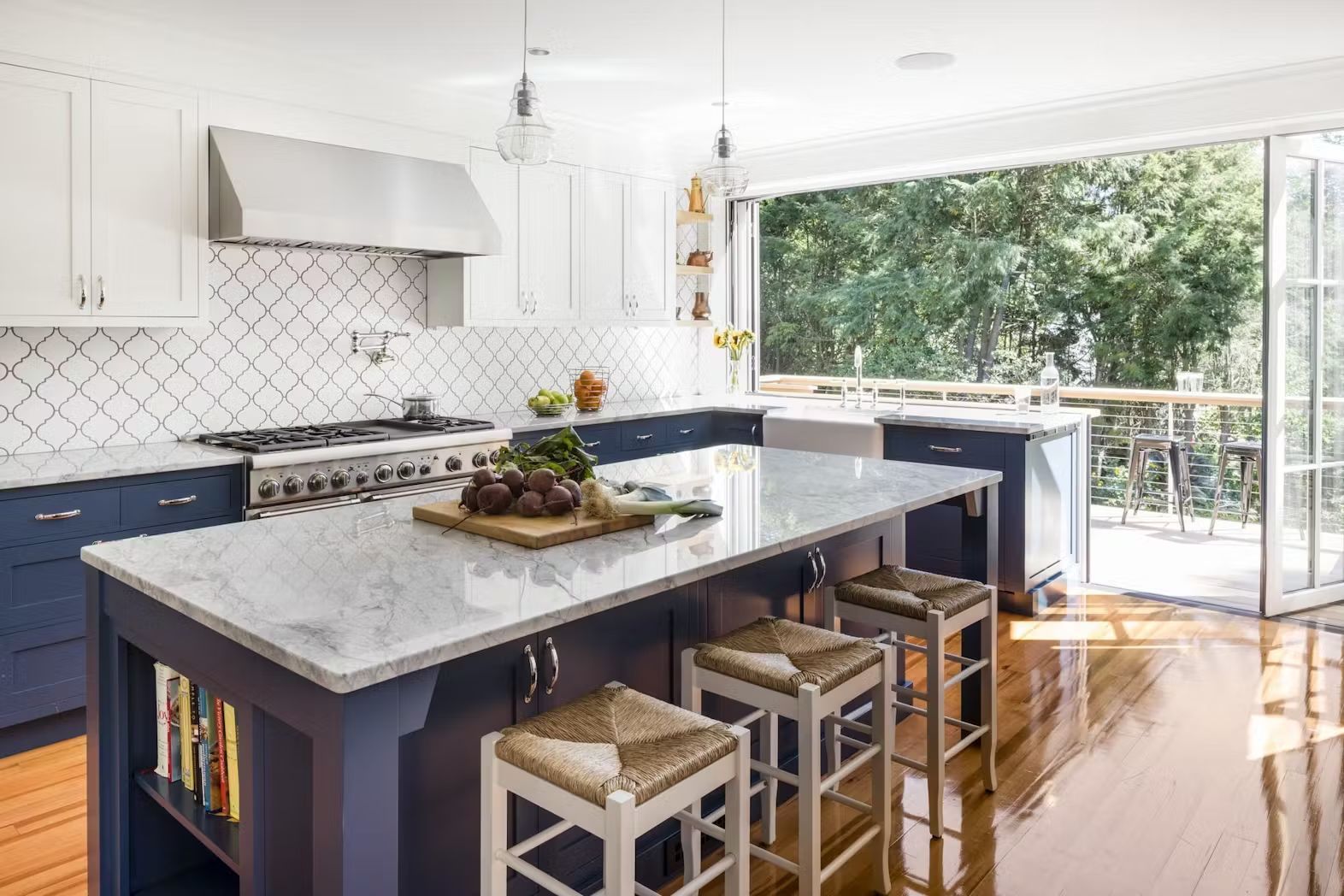 A kitchen with a large island in the middle and stools.