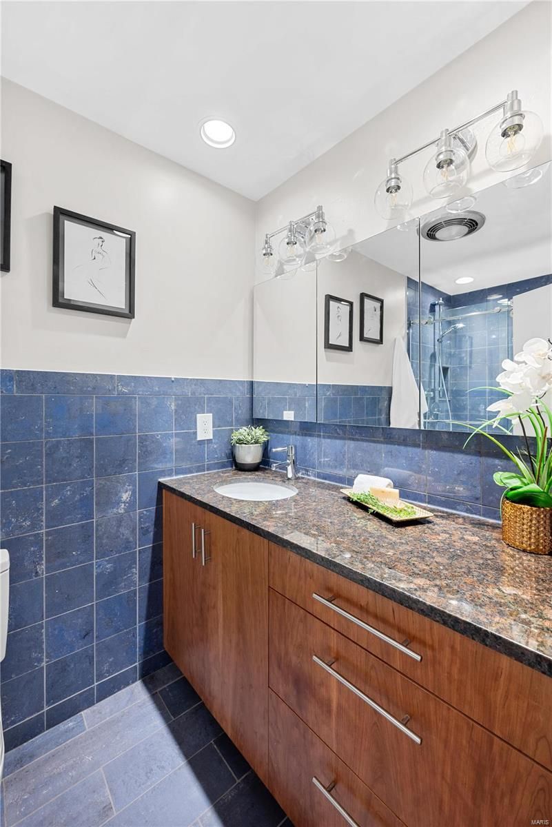 A bathroom with two sinks and a large mirror.