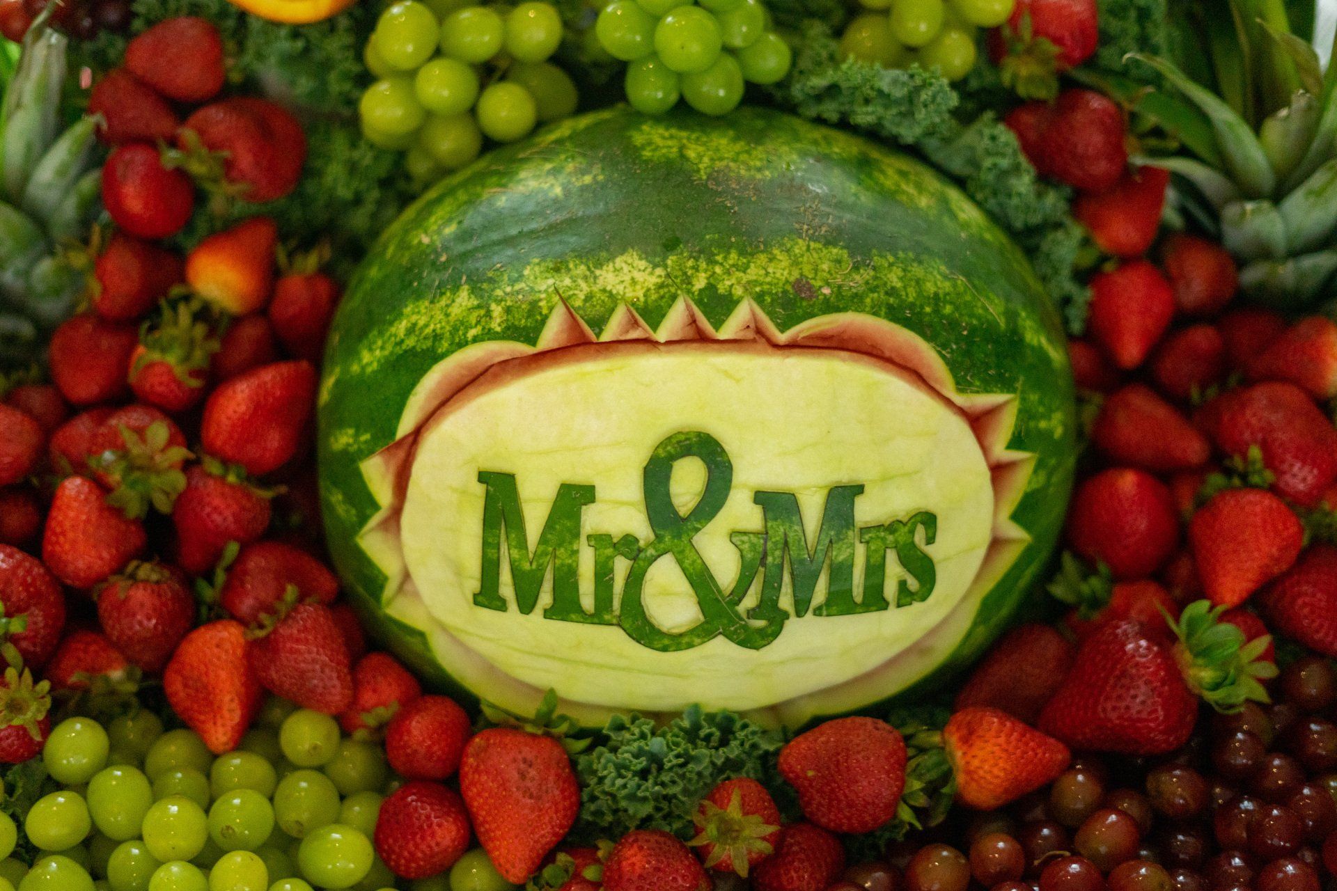 A watermelon with the words mr and mrs carved into it