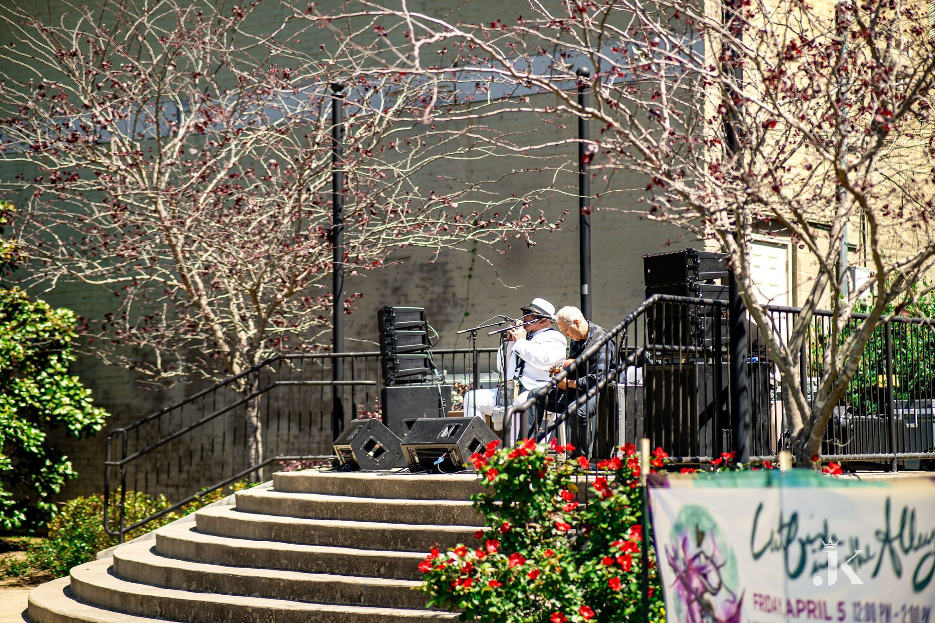 A couple of people are sitting on a set of stairs.