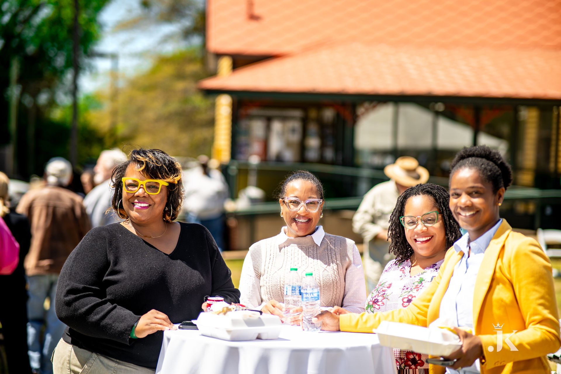 A group of women are standing next to each other at a table.