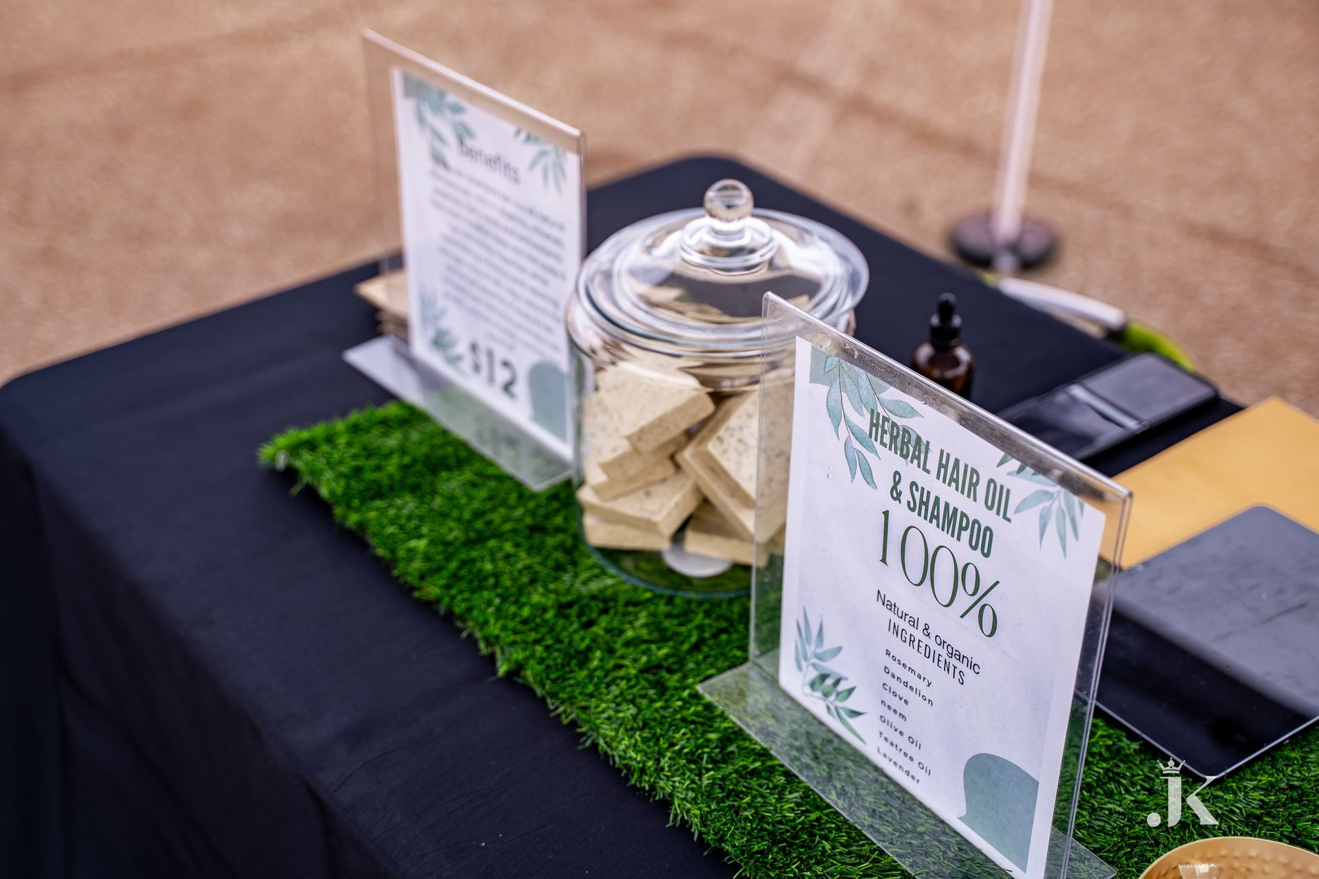 A table with a jar of soap and a sign on it.