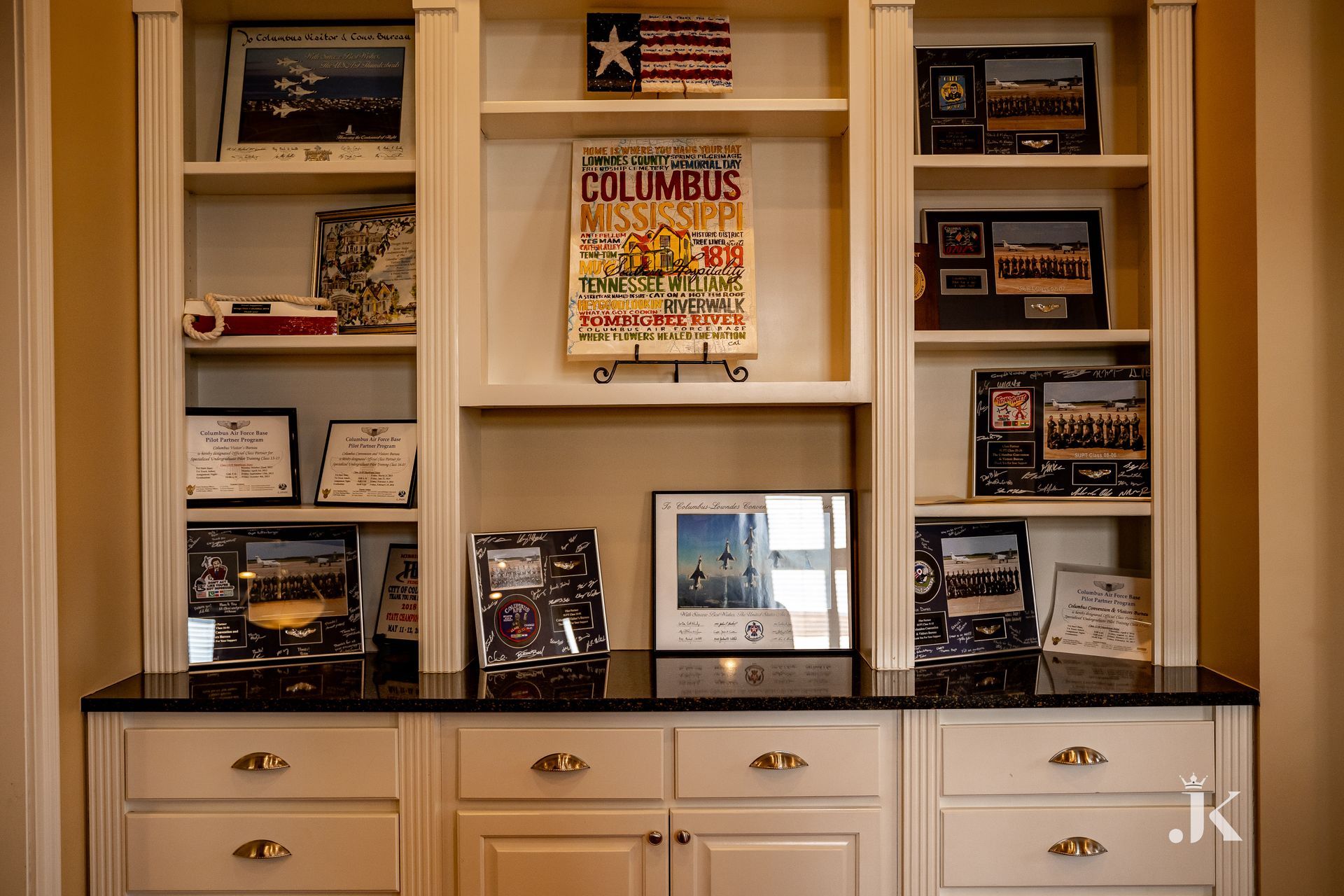 A bookshelf with a columbus magazine on it