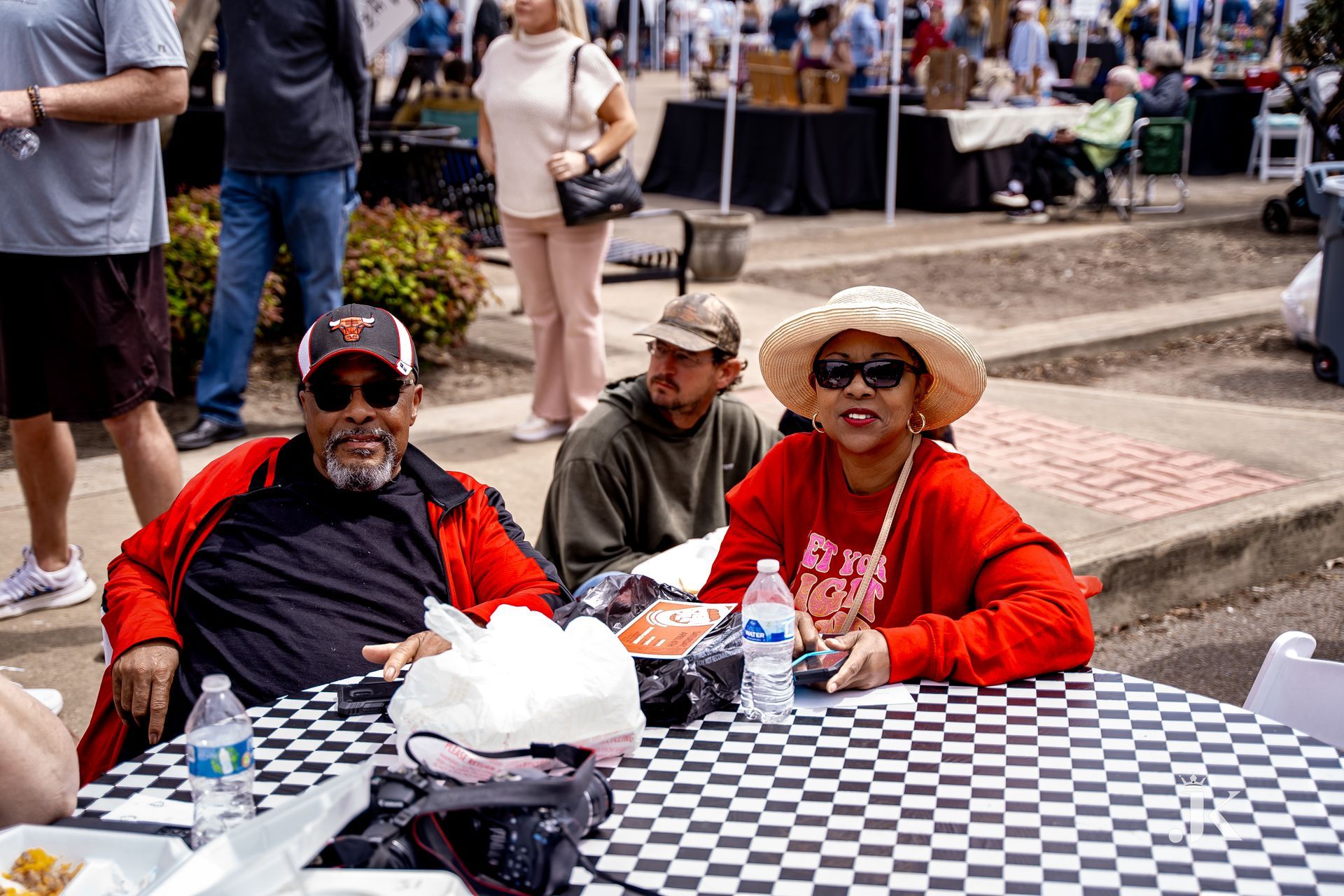 A man and a woman are sitting at a table with cotton candy.