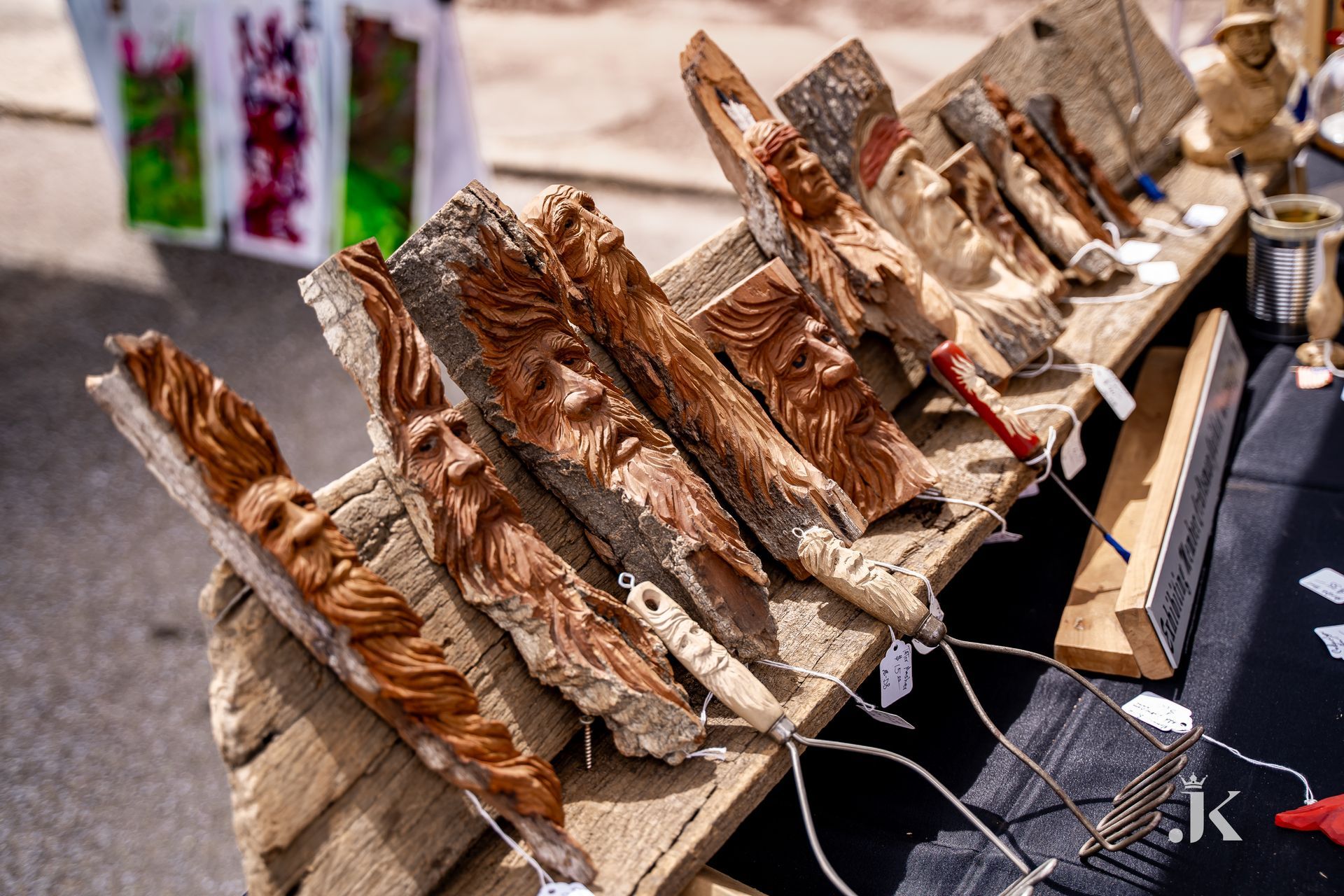 A table with a bunch of wood carvings on it