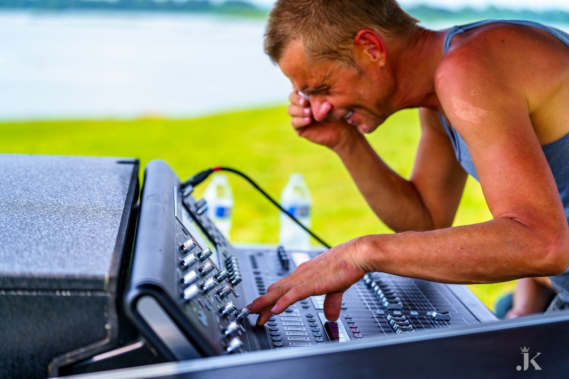 A man is playing a keyboard with the letter k on it