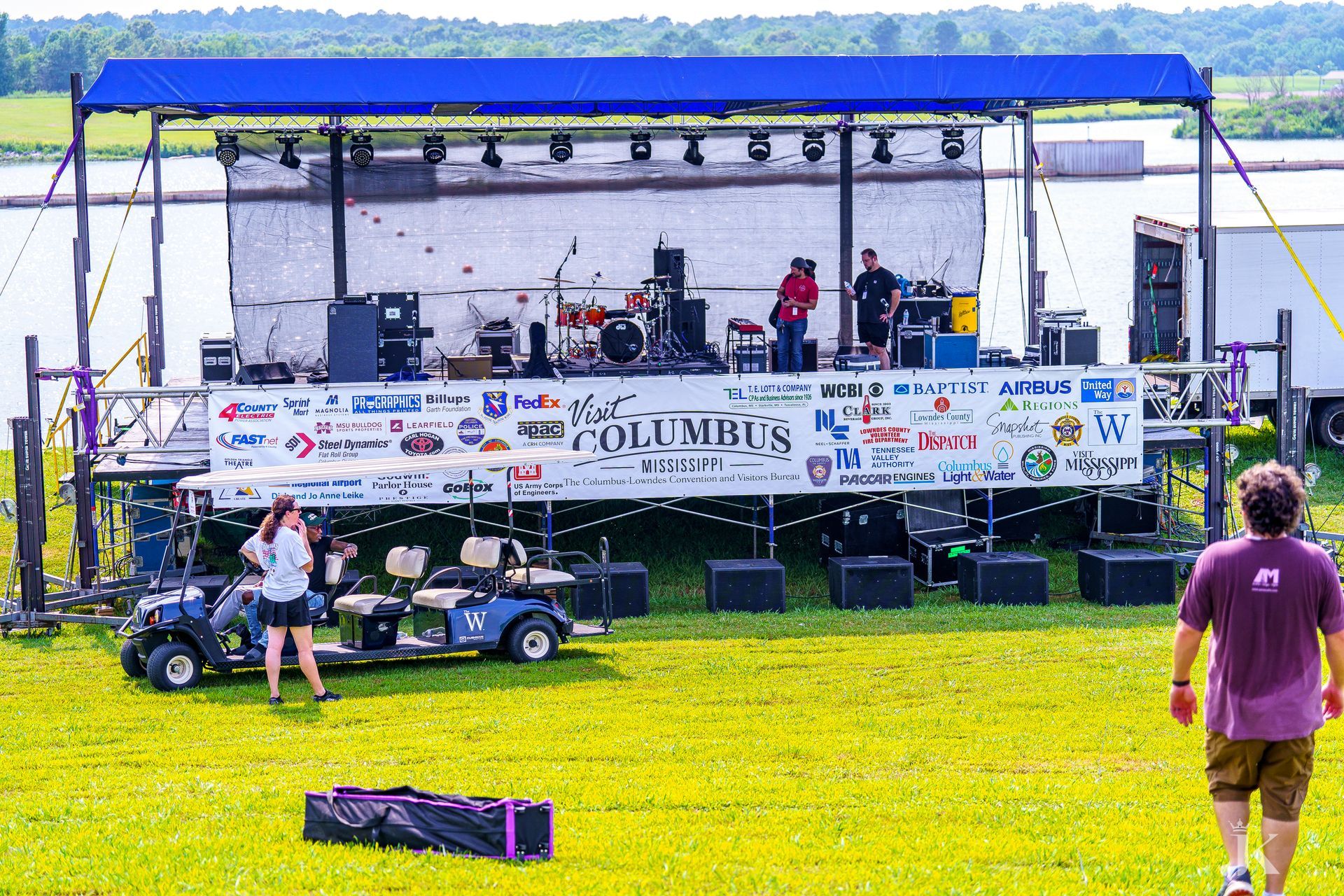 A man is standing in front of a stage that says columbus on it.