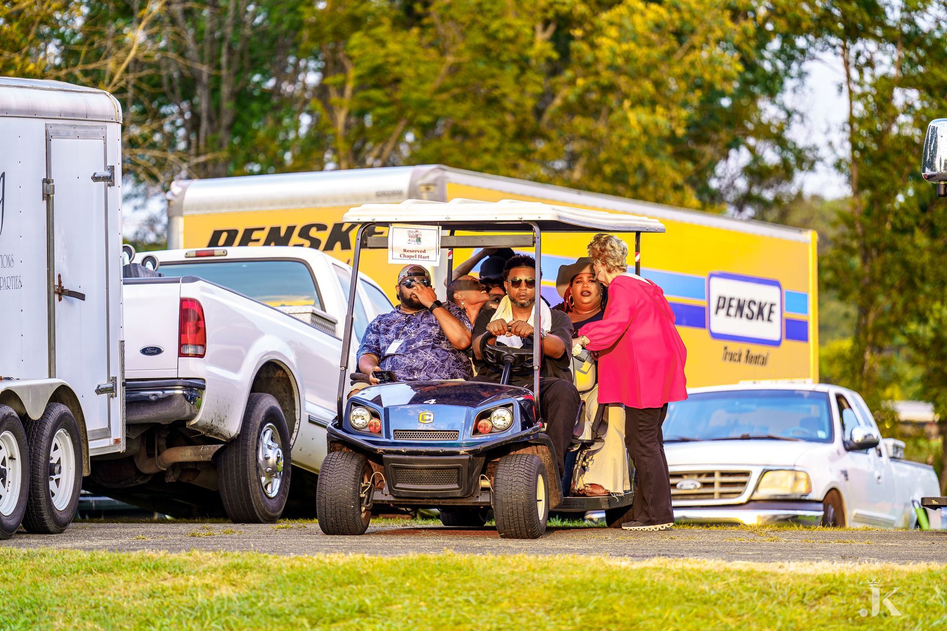 A group of people are sitting in a golf cart.