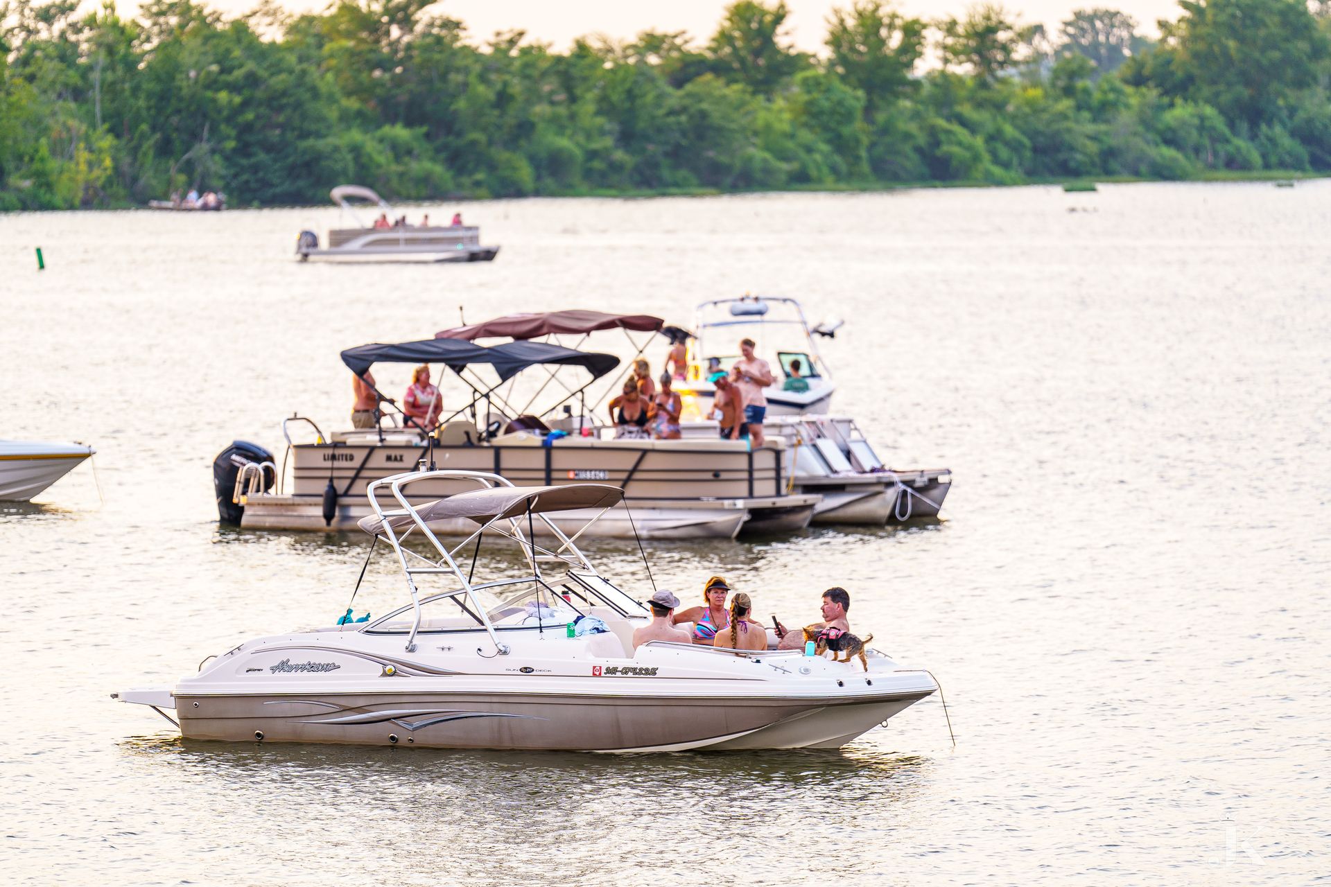 A group of people are riding boats on a lake.