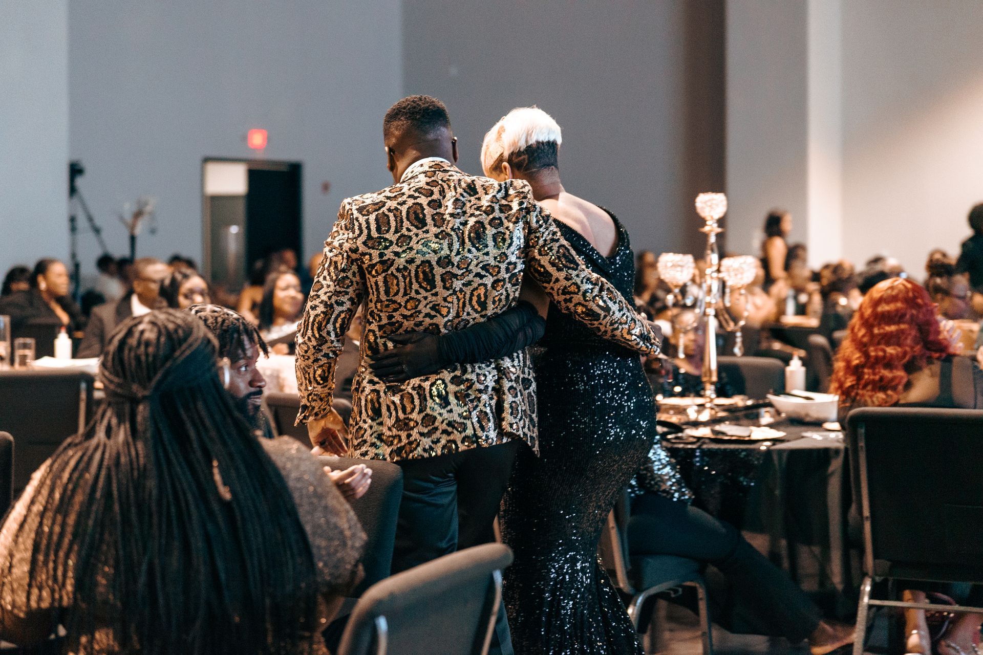 A group of people are sitting at tables in a room.