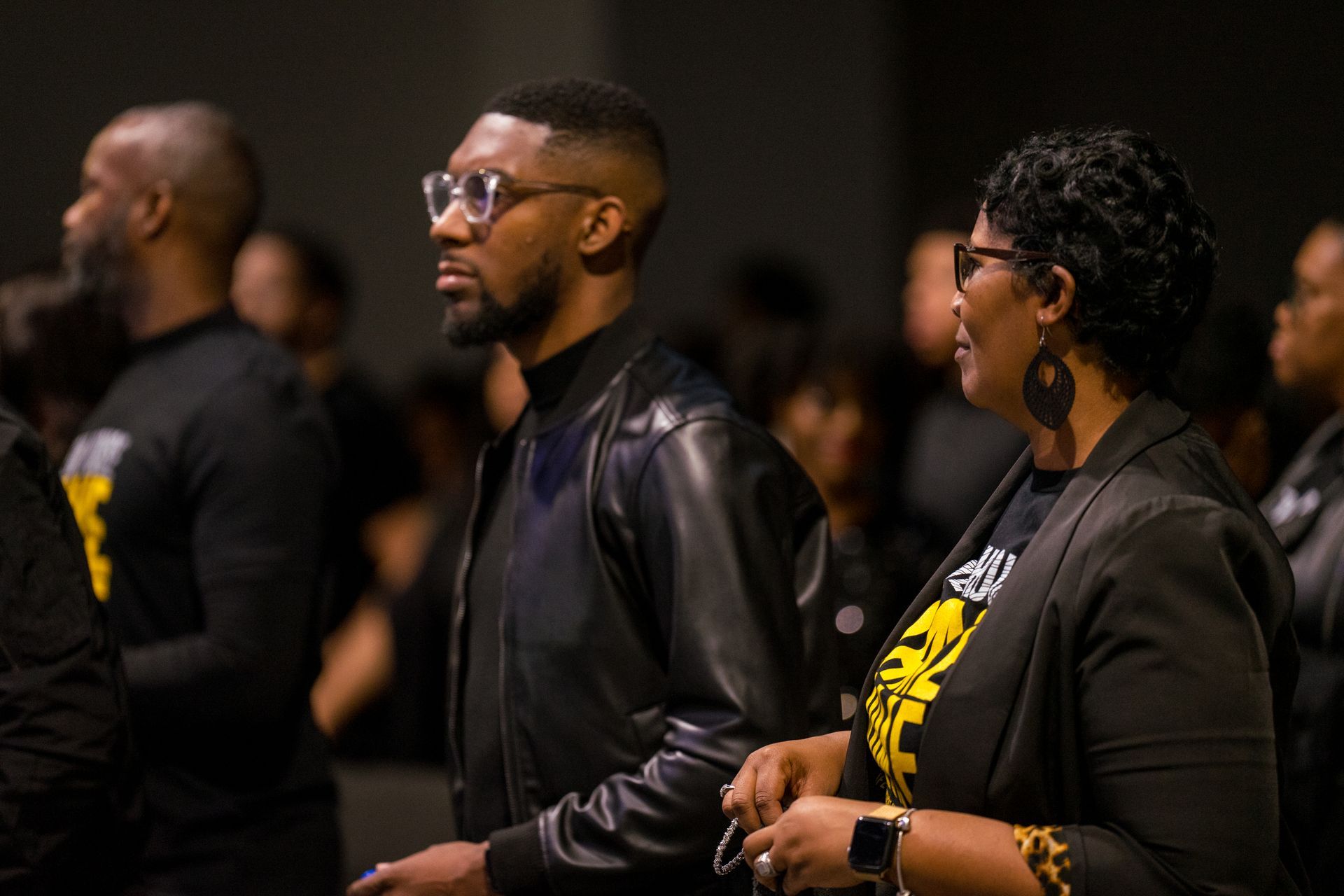 A man and a woman are standing next to each other in a crowd.