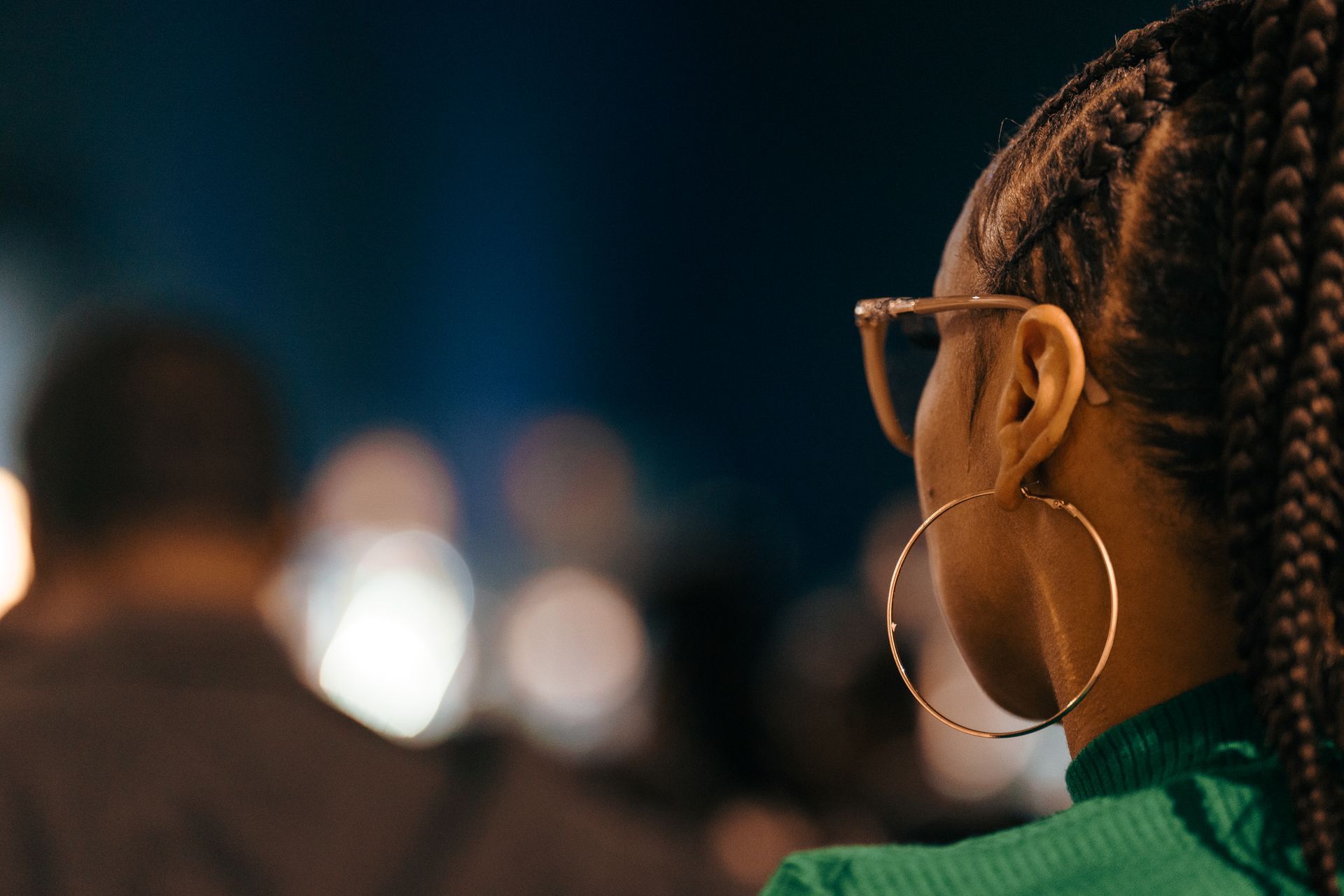 A close up of a woman wearing hoop earrings.