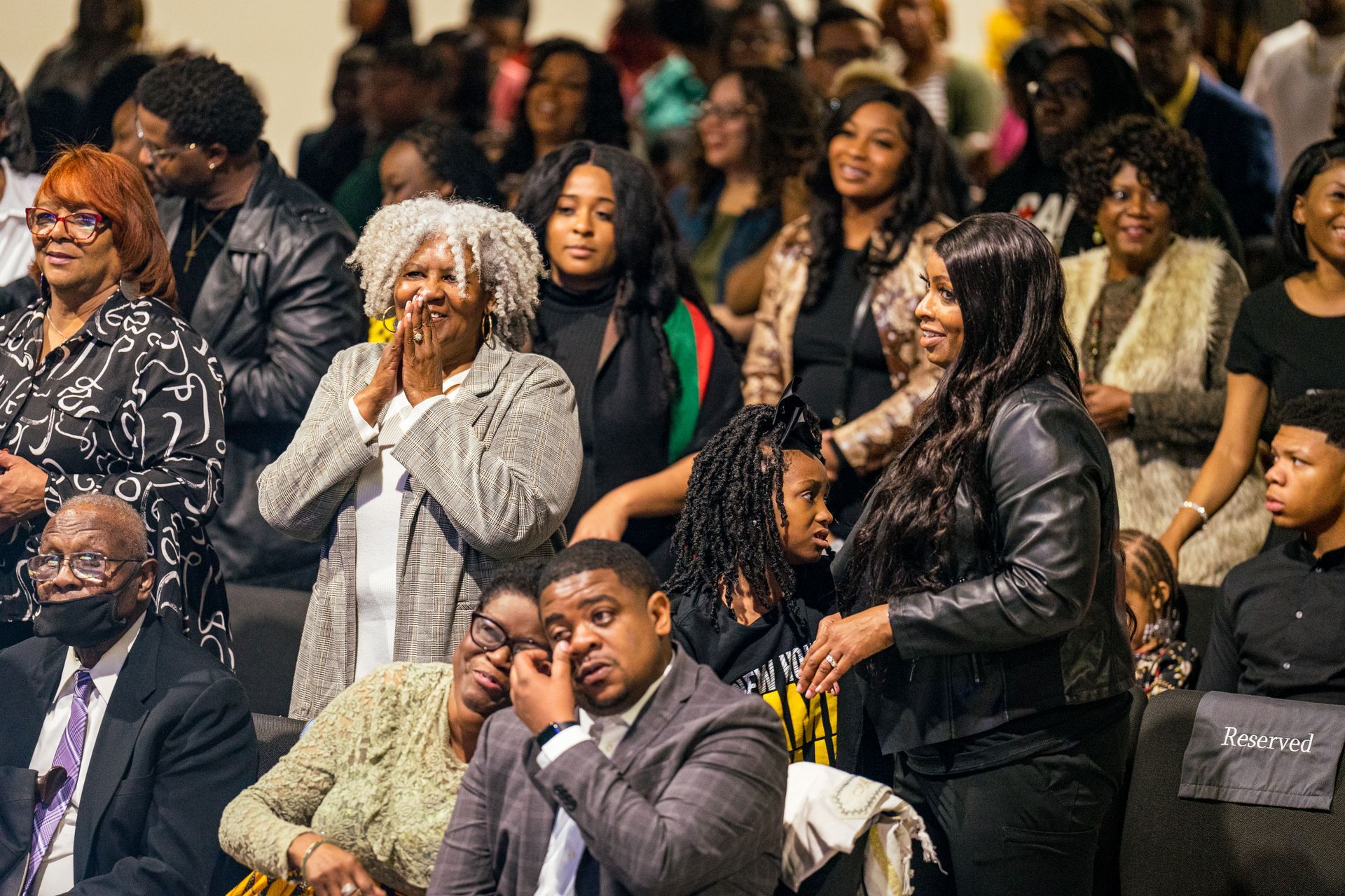 A large group of people are sitting in a stadium.