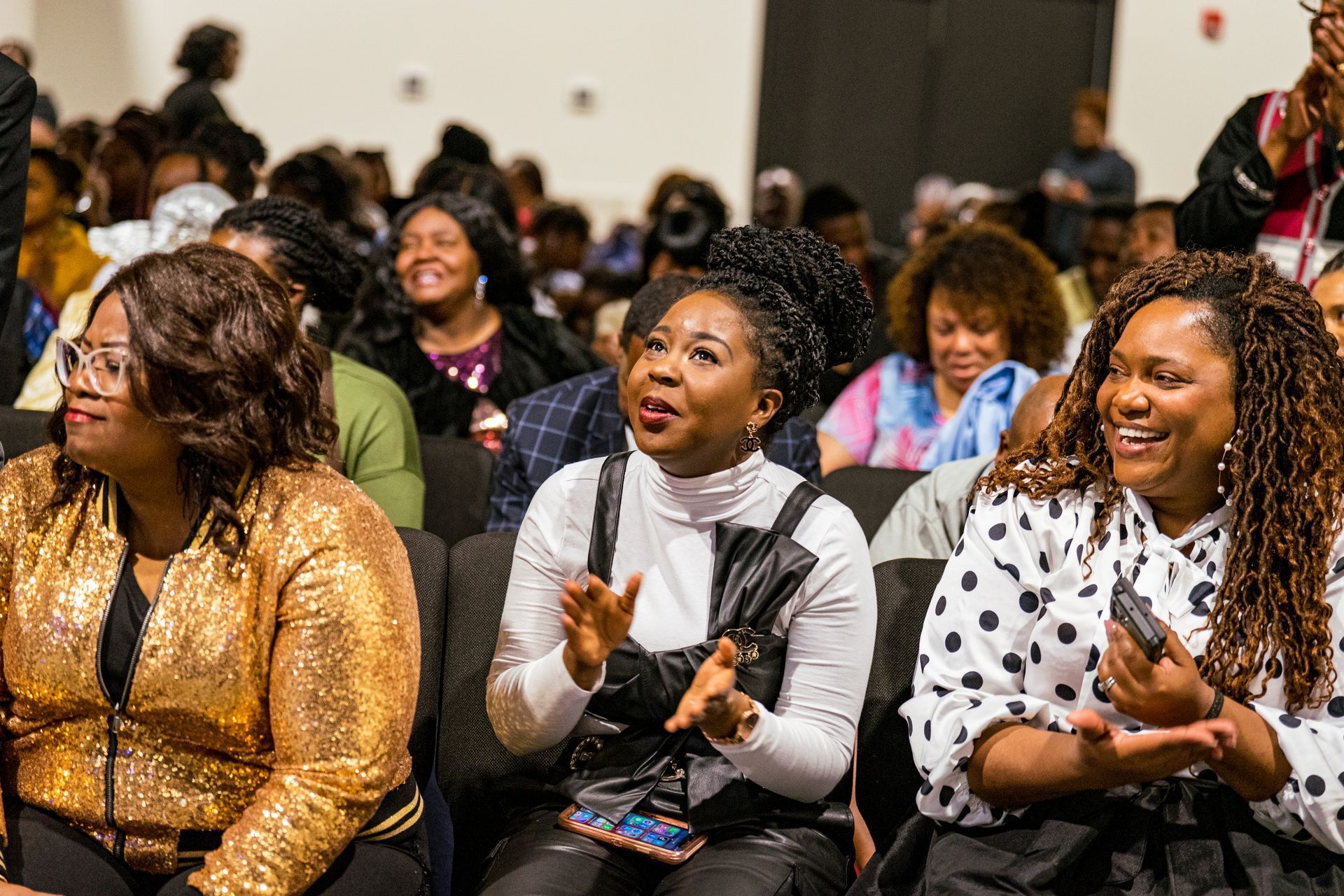 A group of women are sitting in chairs in a room.