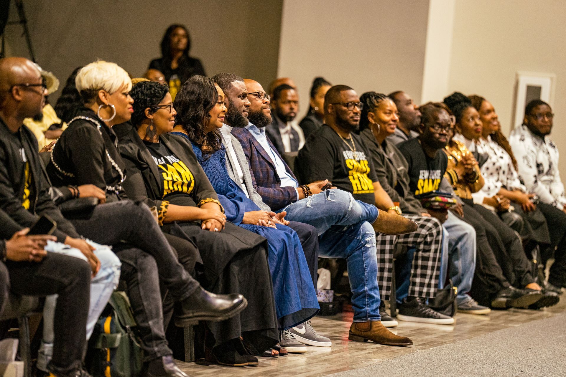 A group of people are sitting in chairs in a room.