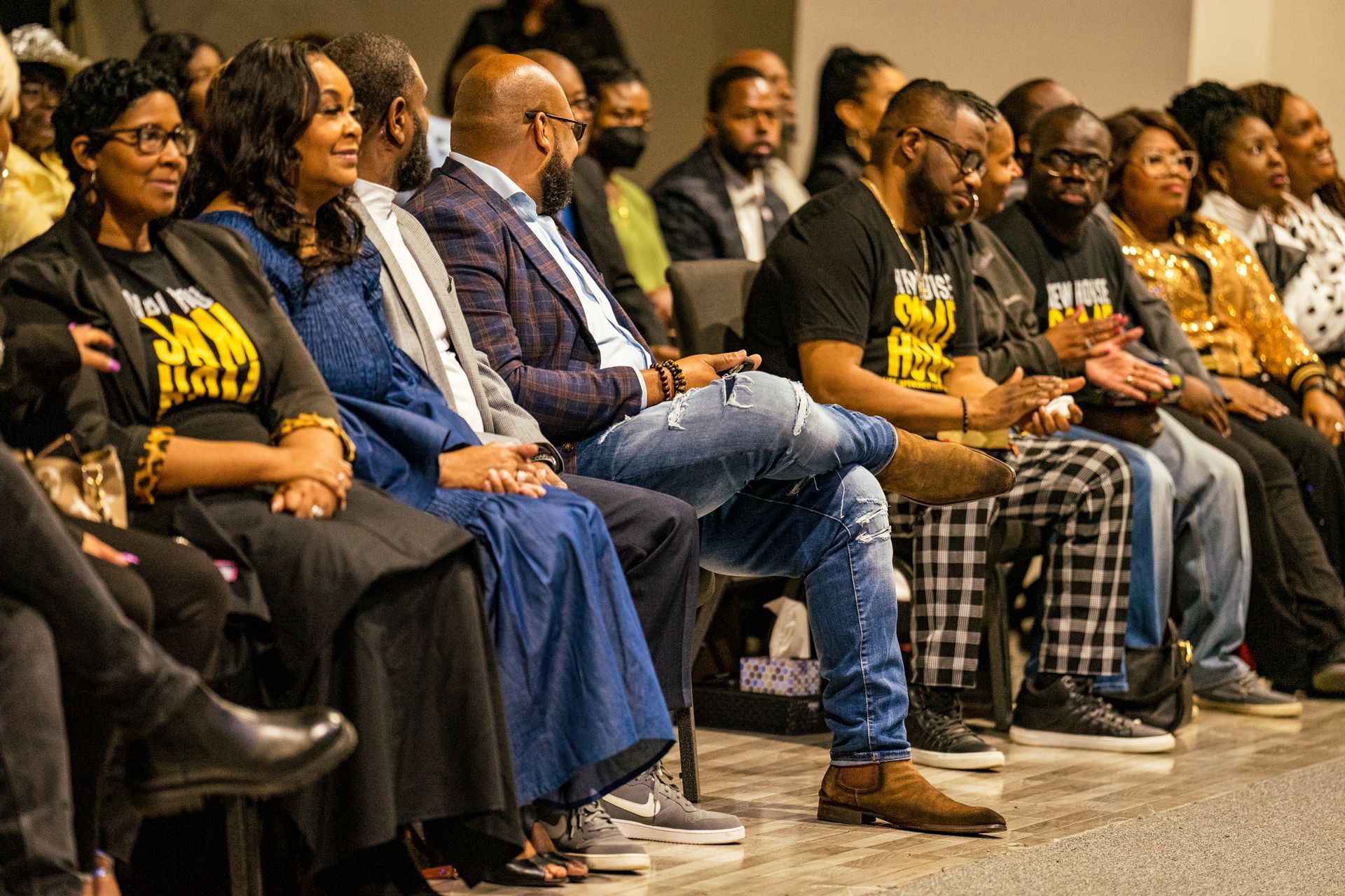 A group of people are sitting in chairs in a room.