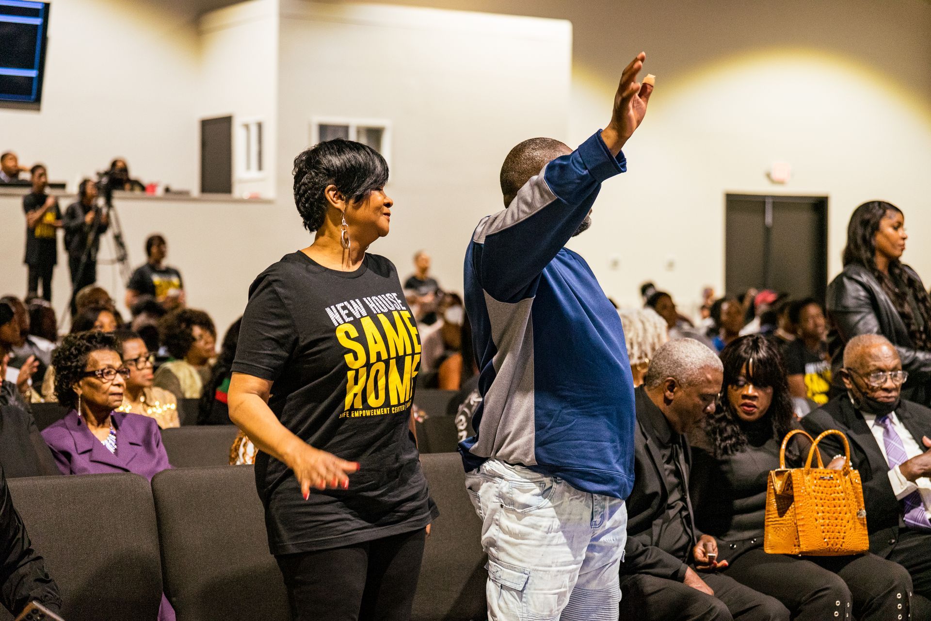 A man and a woman are dancing in front of a crowd of people in a church.