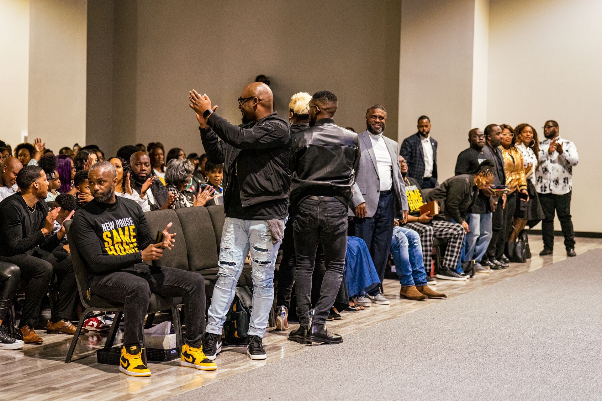 A group of people are sitting in chairs in a room.