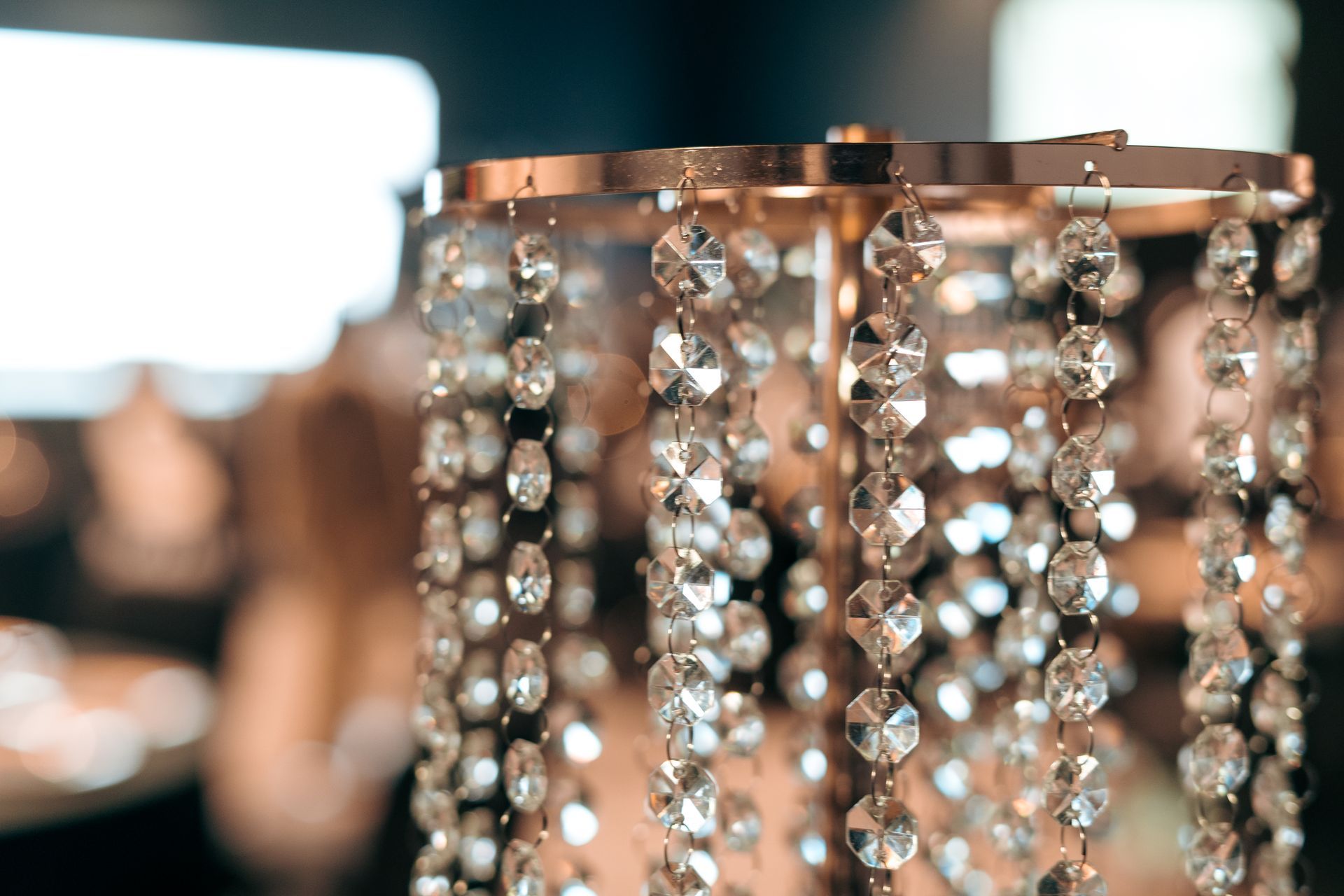 A close up of a chandelier with crystals hanging from it.