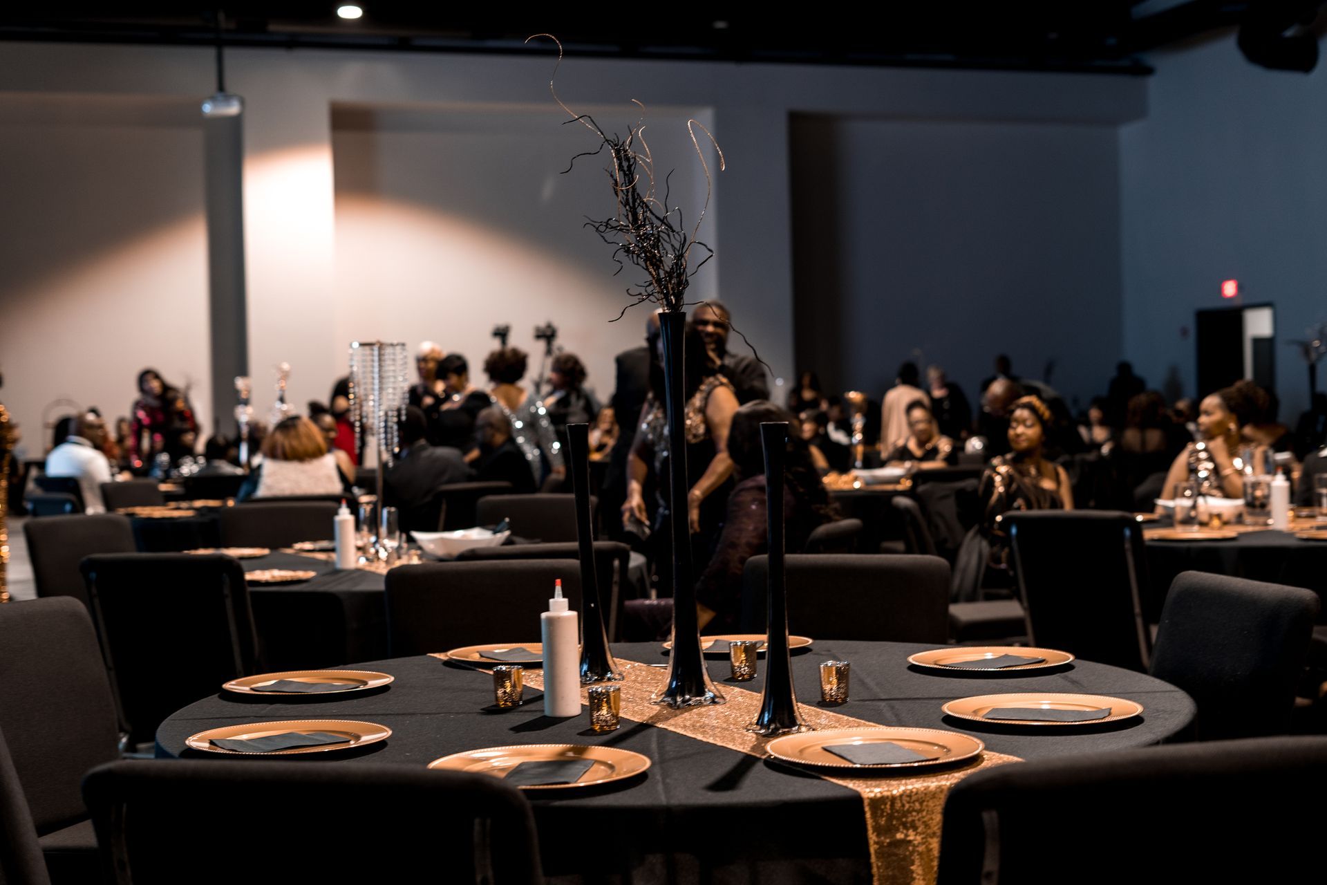 A large room with tables and chairs set up for a party.