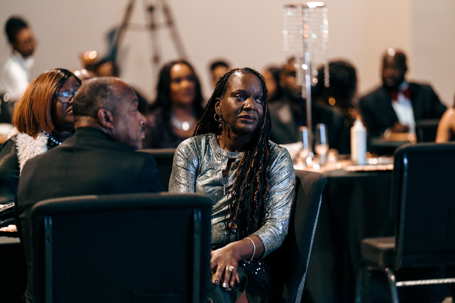 A group of people are sitting at a table in a room.
