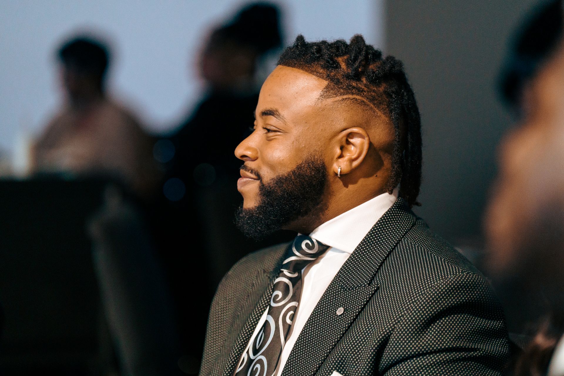 A man with a beard is wearing a suit and tie.