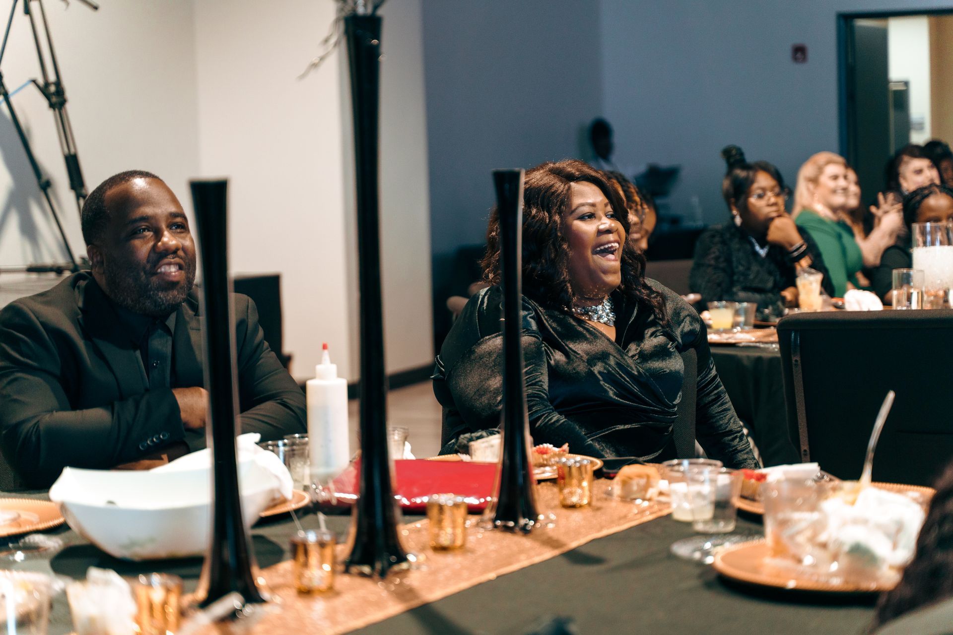 A group of people are sitting at a table laughing.