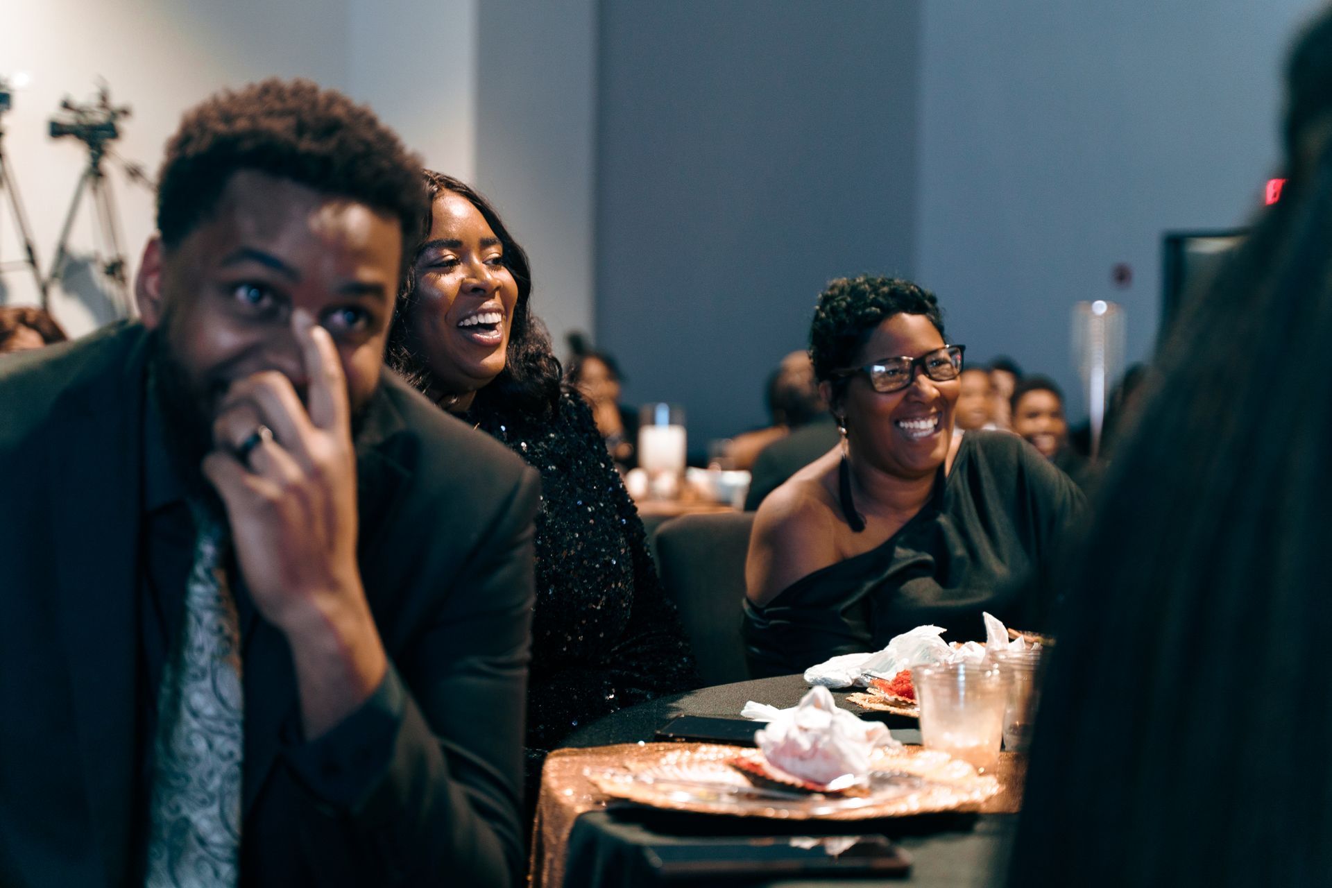 A group of people are sitting at a table at a party.