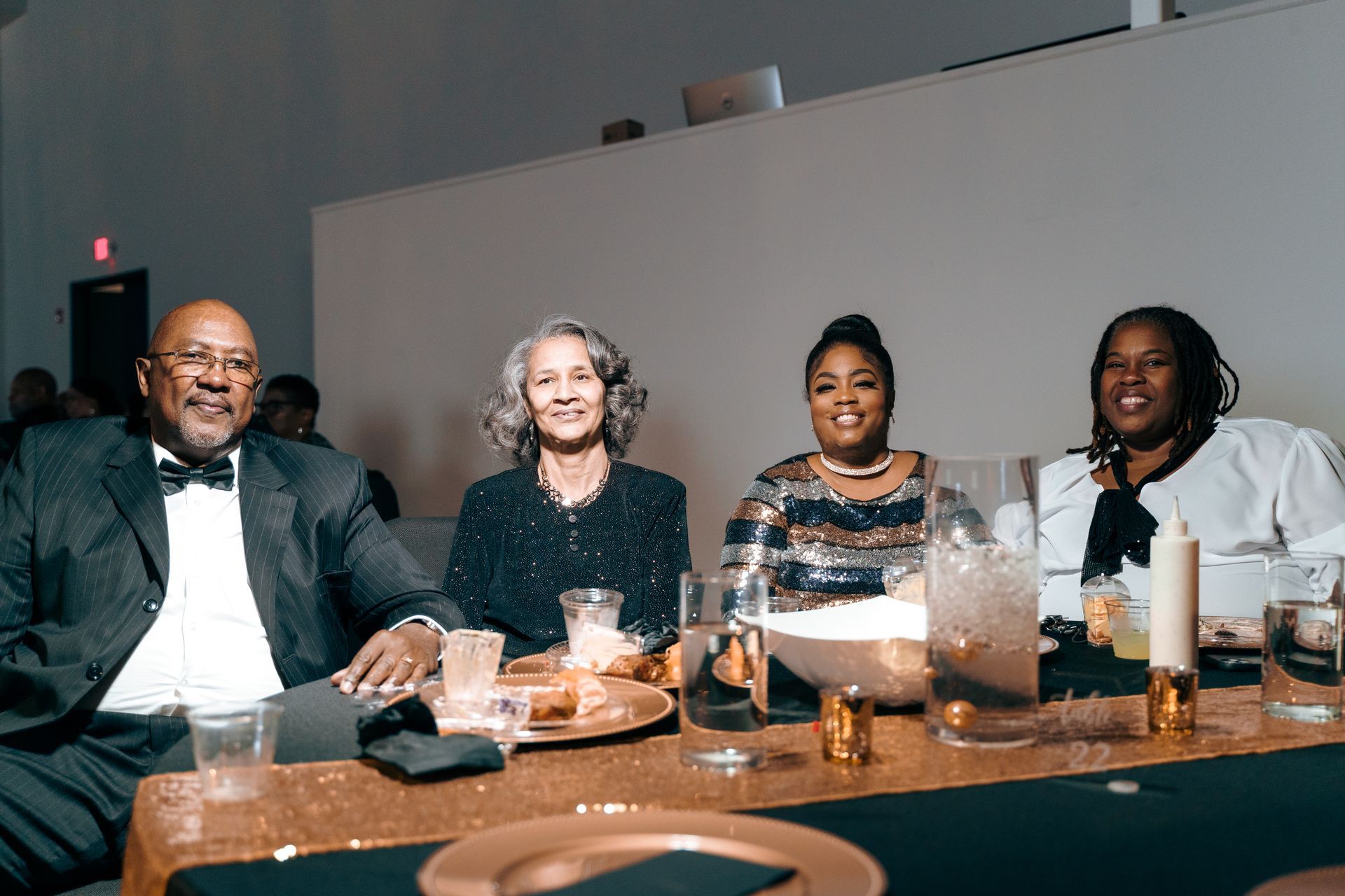 A group of people are sitting at a table with glasses of wine.