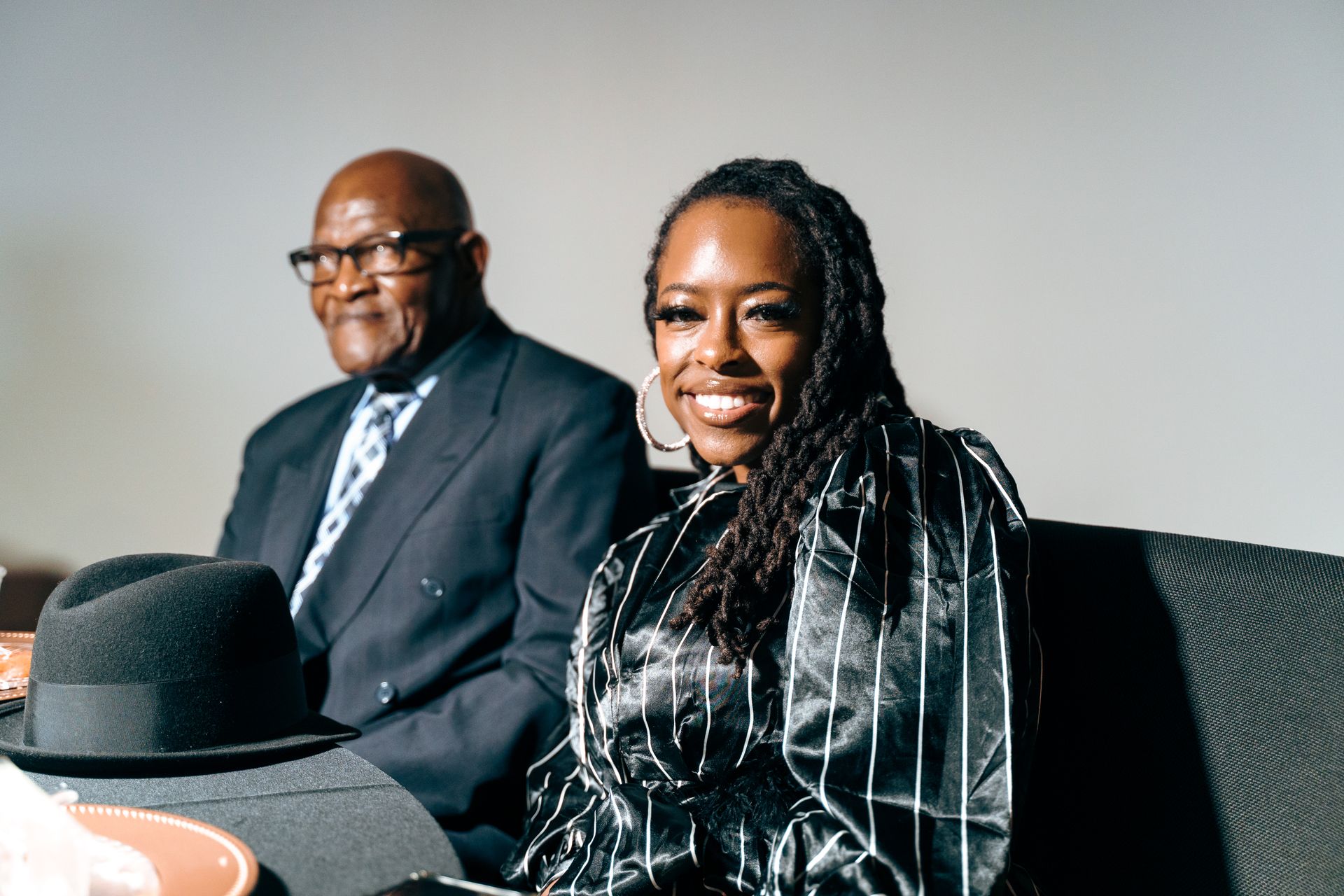 A man and a woman are sitting next to each other on a couch.