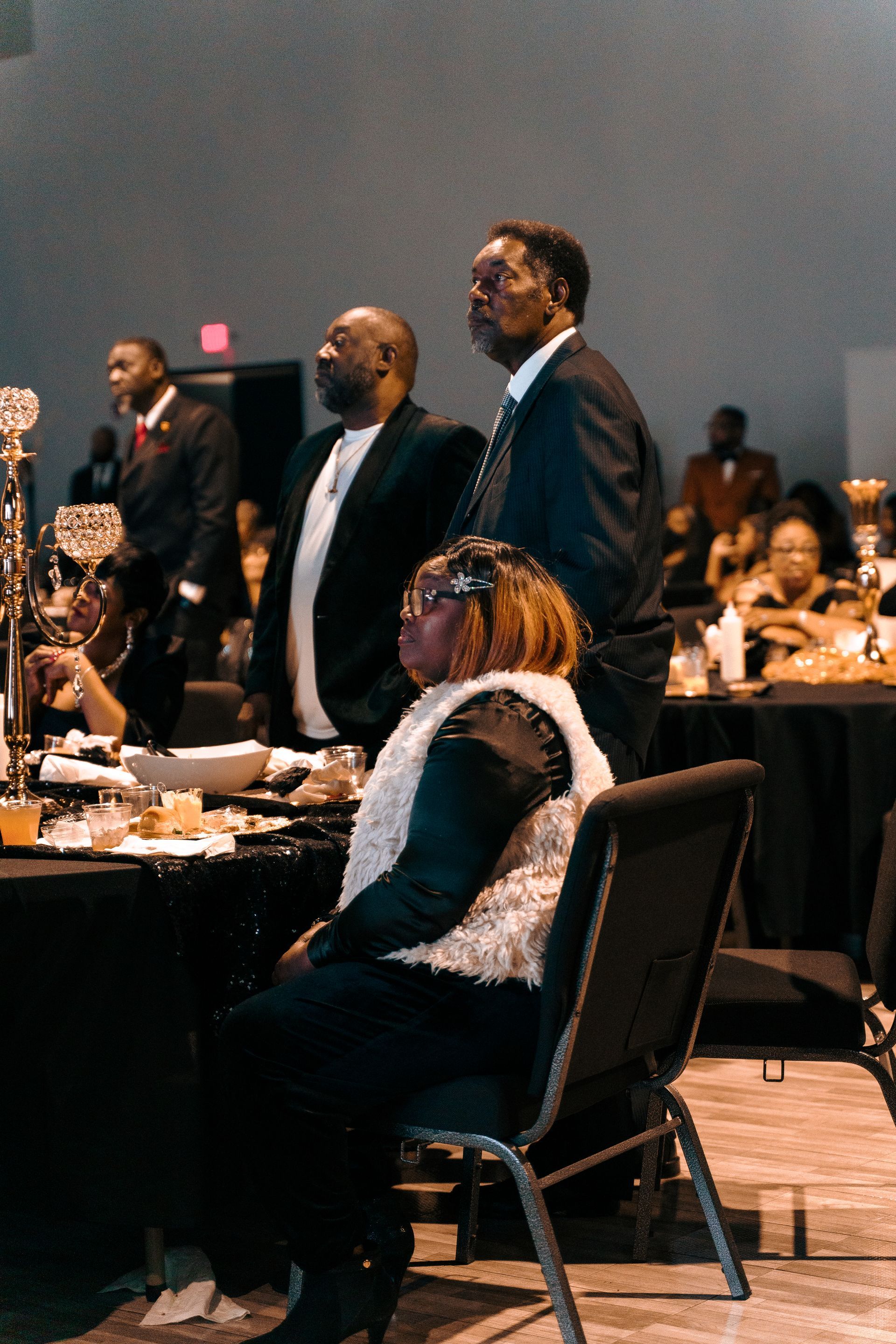 A group of people are sitting at tables at a banquet.