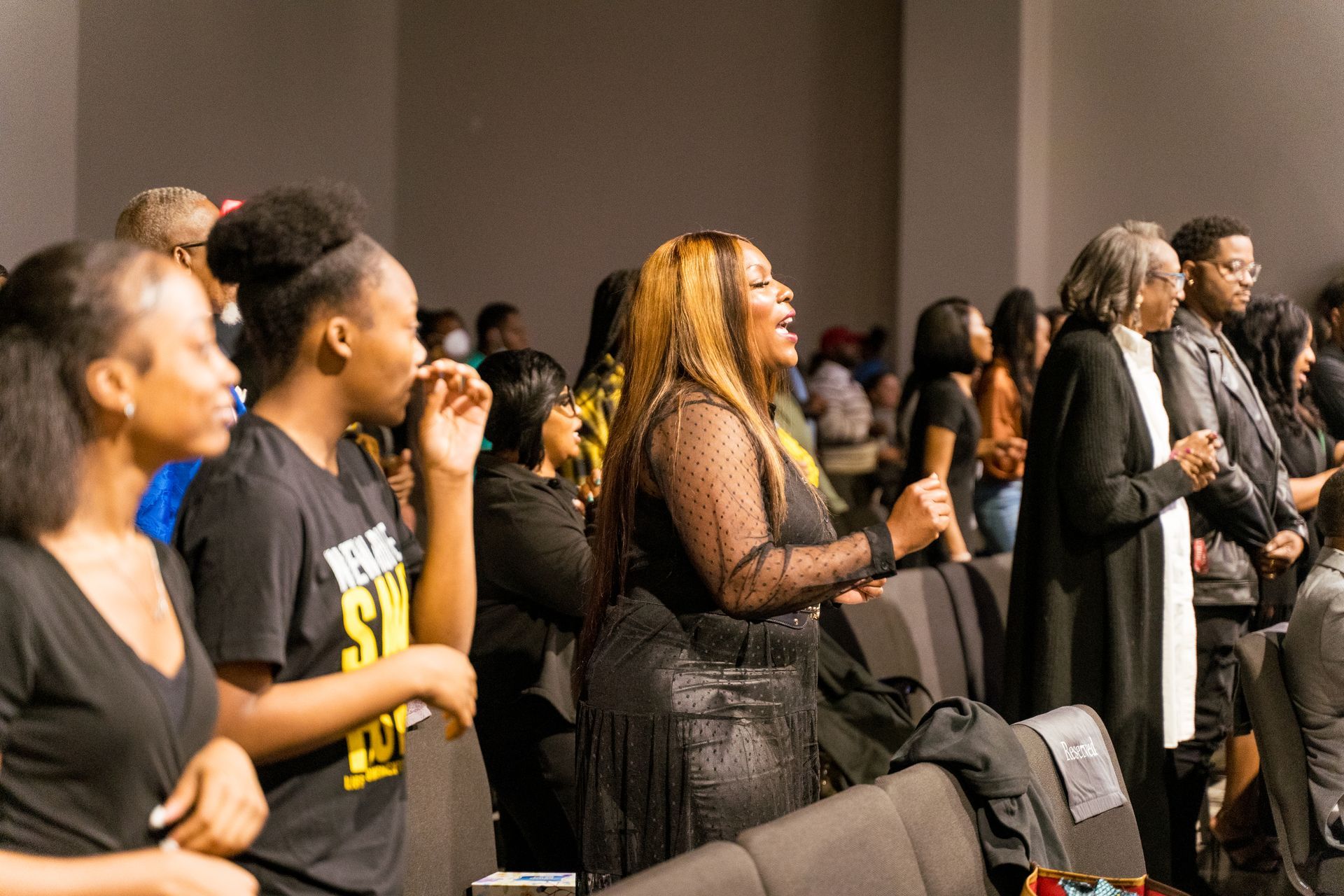 A group of people are standing in a room.