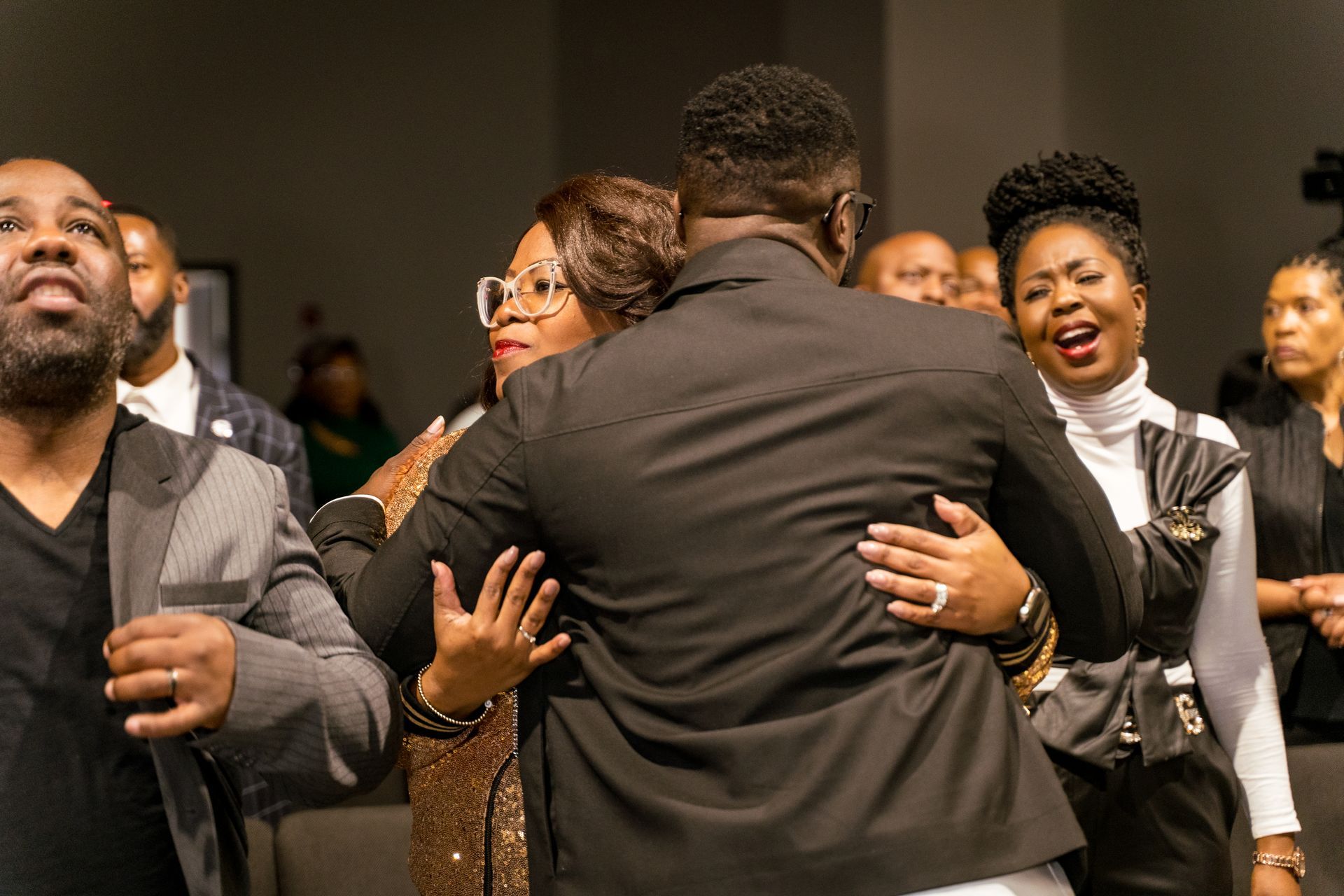 A group of people are dancing together in a room.