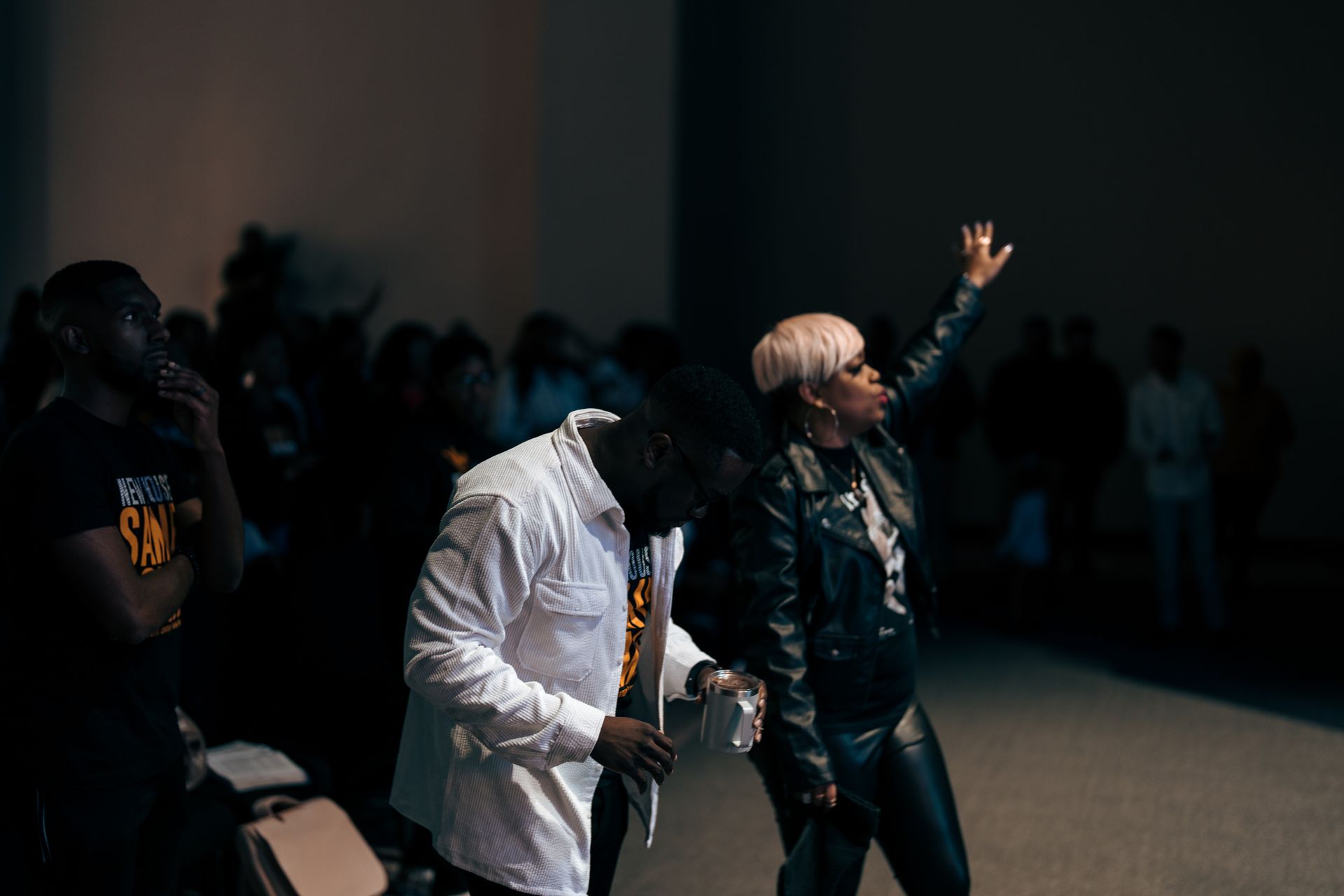 A man and a woman are standing next to each other in a dark room.