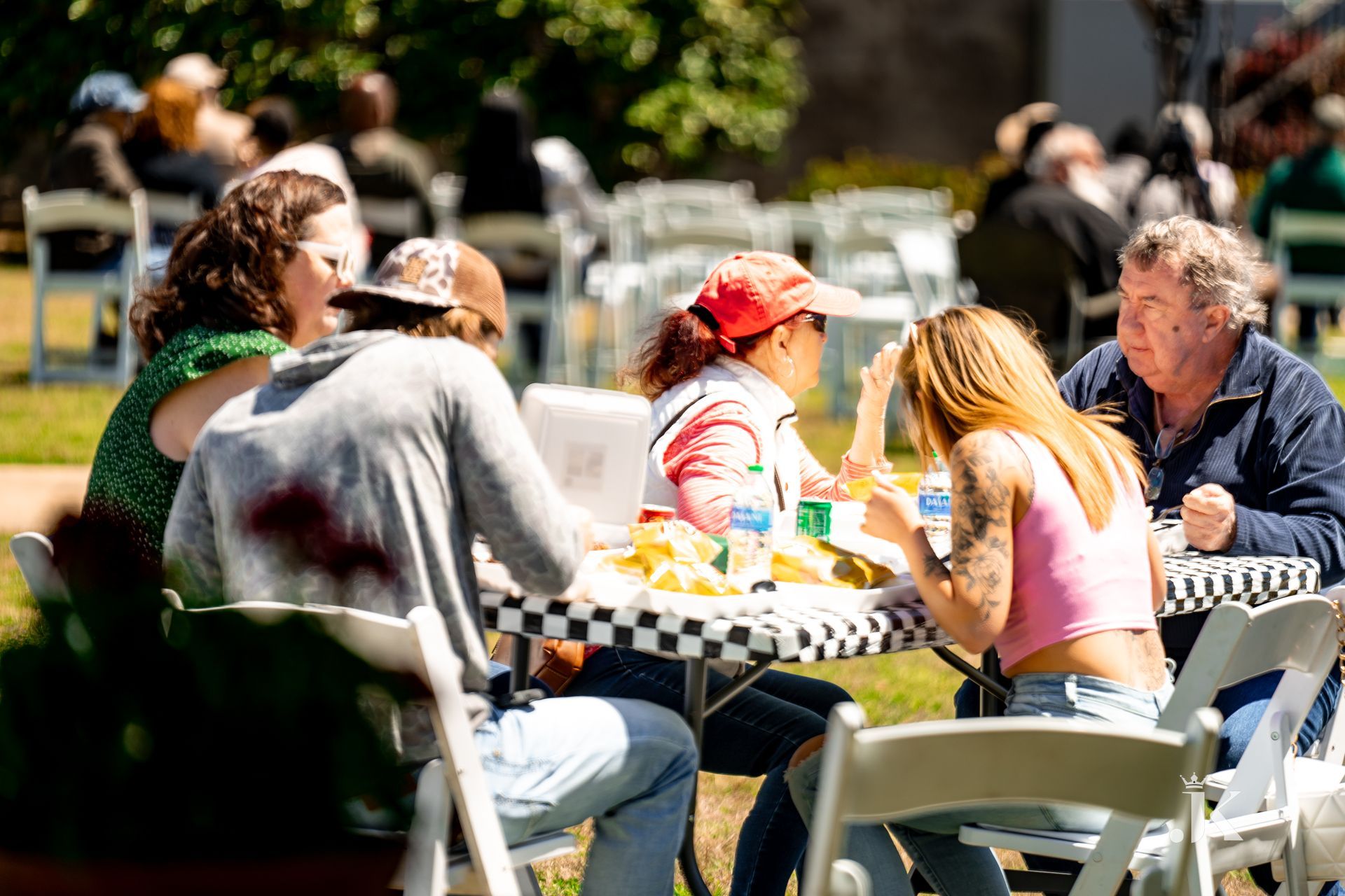 A group of people are sitting at a table eating food.