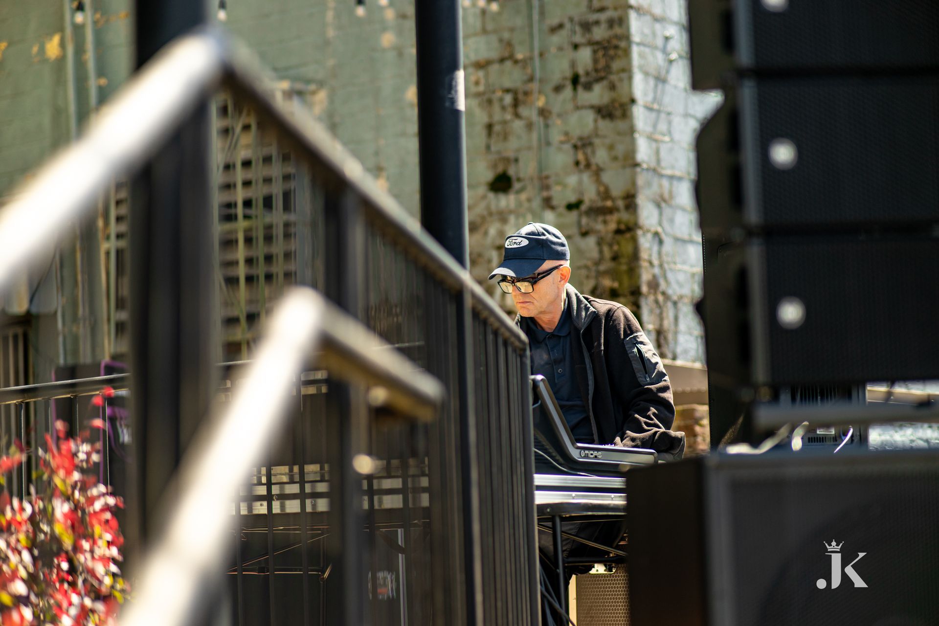 A man is sitting at a table using a laptop computer.